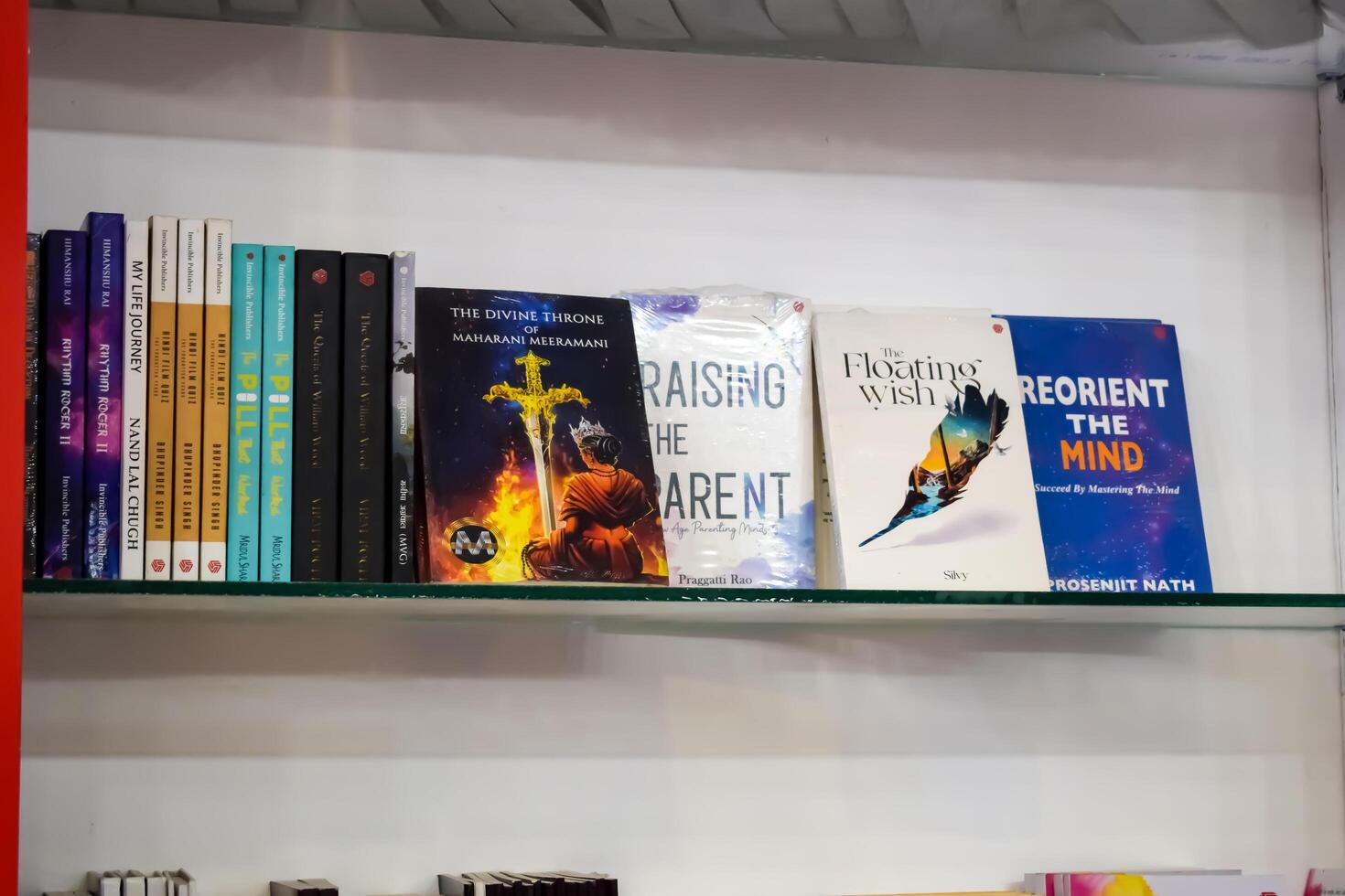 New Delhi, India, February 17 2024 - Variety of Books on shelf inside a book-stall at Delhi International Book Fair, Selection of books on display in Annual Book Fair at Bharat Mandapam complex photo