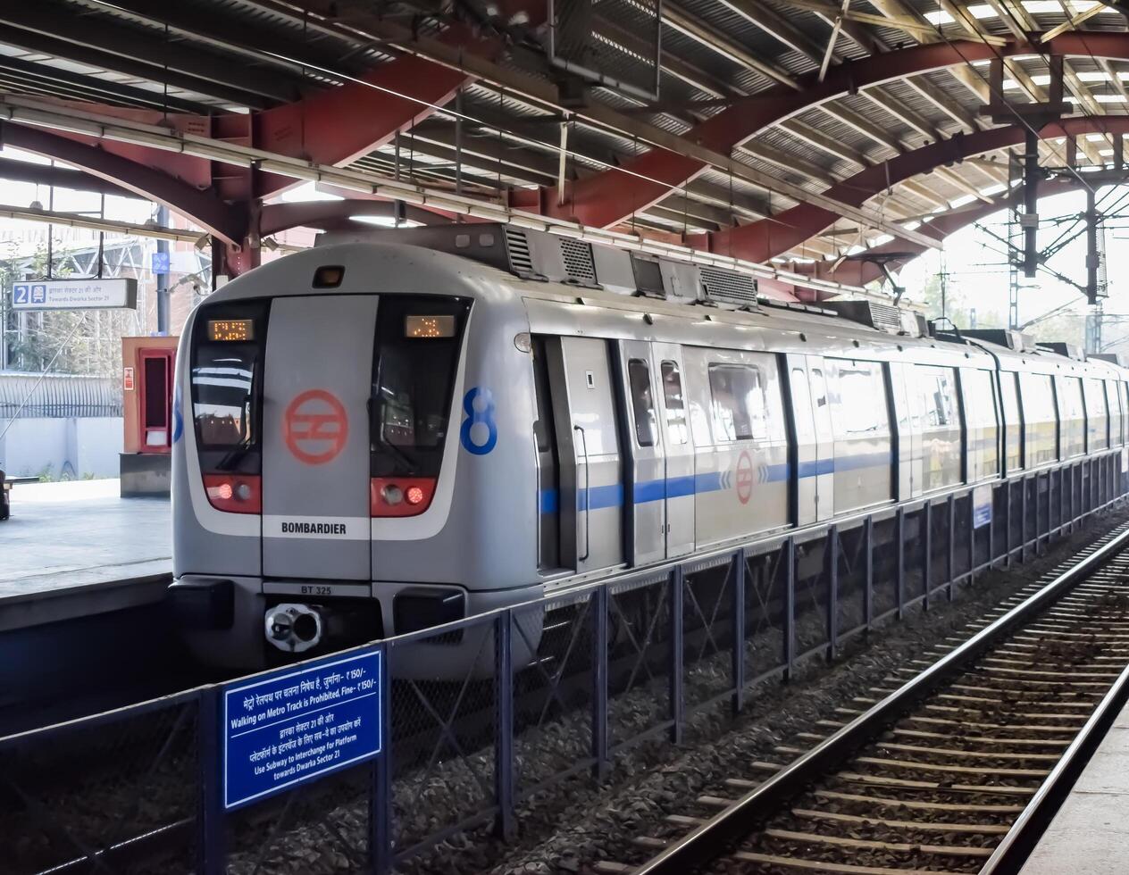 New Delhi, India, February 17 2024 - Delhi Metro train arriving at Jhandewalan metro station in New Delhi, India, Asia, Public Metro departing from Jhandewalan station photo