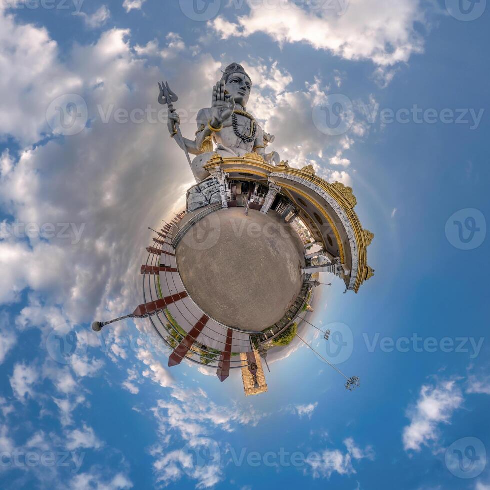 tallest hindu shiva statue in india on mountain near ocean on little planet in blue sky with evening clouds, transformation of spherical 360 panorama. Spherical abstract view with curvature of space. photo