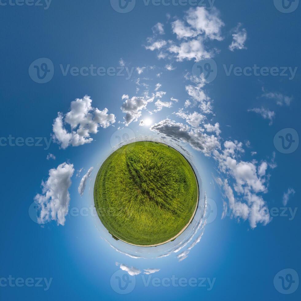 simple tiny planet without buildings in blue sky with beautiful clouds. Transformation of spherical panorama 360 degrees. Spherical abstract aerial view. Curvature of space. photo