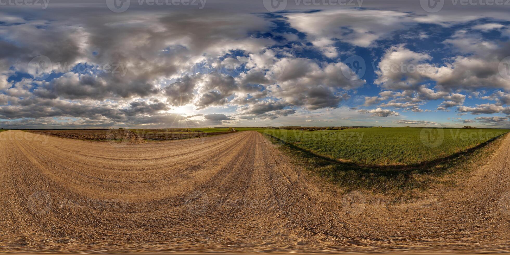 360 hdri panorama view on no traffic gravel road among fields in spring day with beautiful clouds in equirectangular full seamless spherical projection, ready for VR AR photo