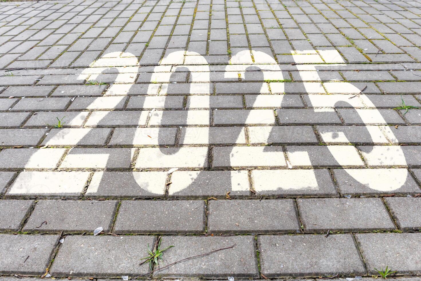 numbers 2025 on paving slabs. concept of destination in future, freedom, work start, run, planning, challenge, target, new year photo