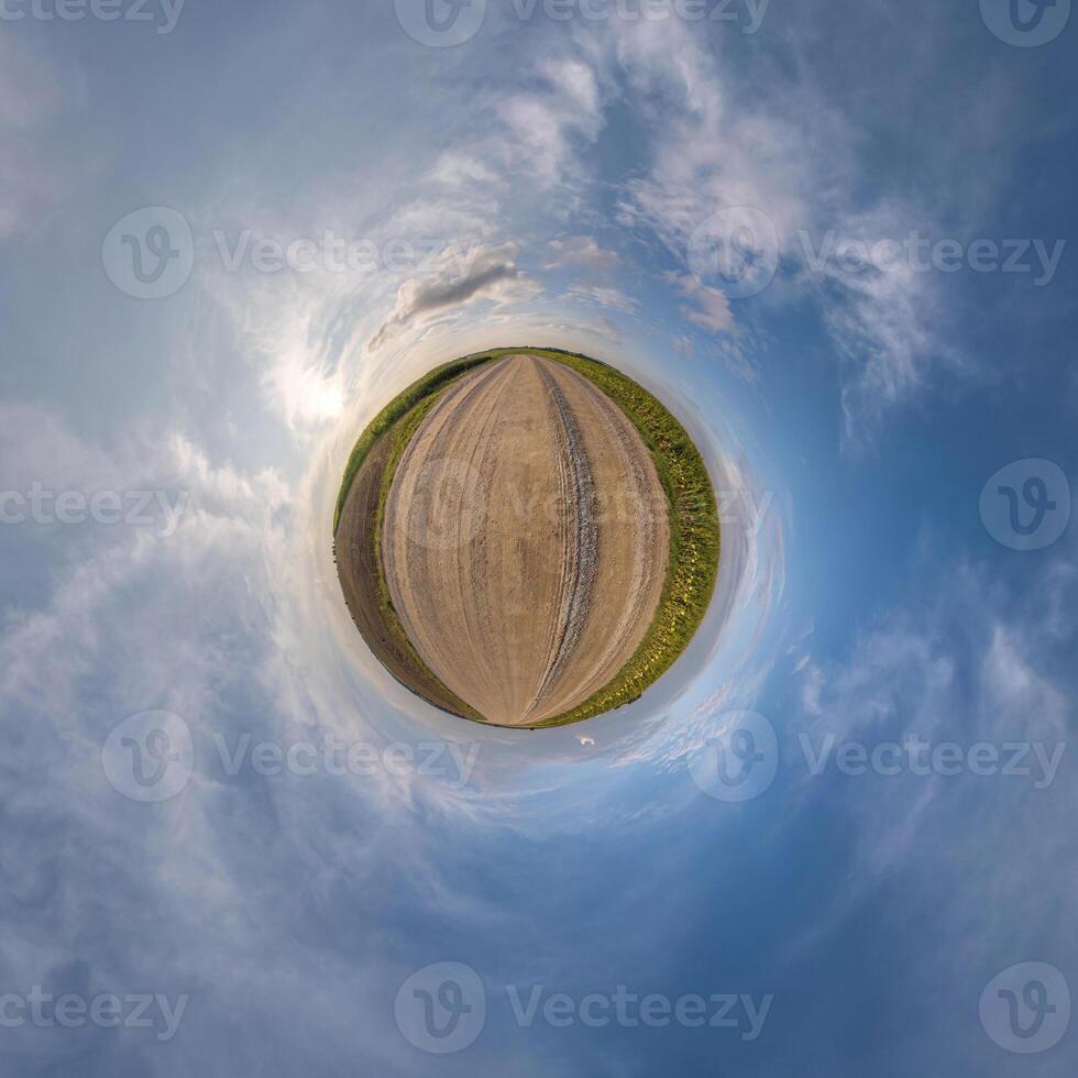 simple tiny planet without buildings in blue sky with beautiful clouds. Transformation of spherical panorama 360 degrees. Spherical abstract aerial view. Curvature of space. photo