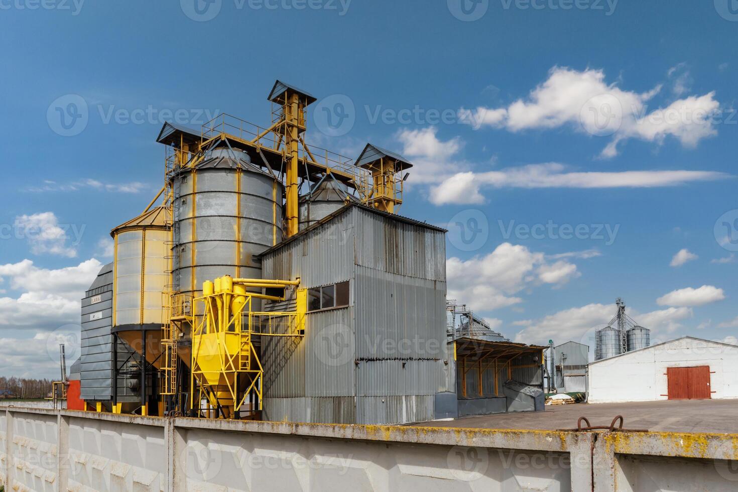 silos on agro-industrial complex with seed cleaning and drying line for grain storage photo