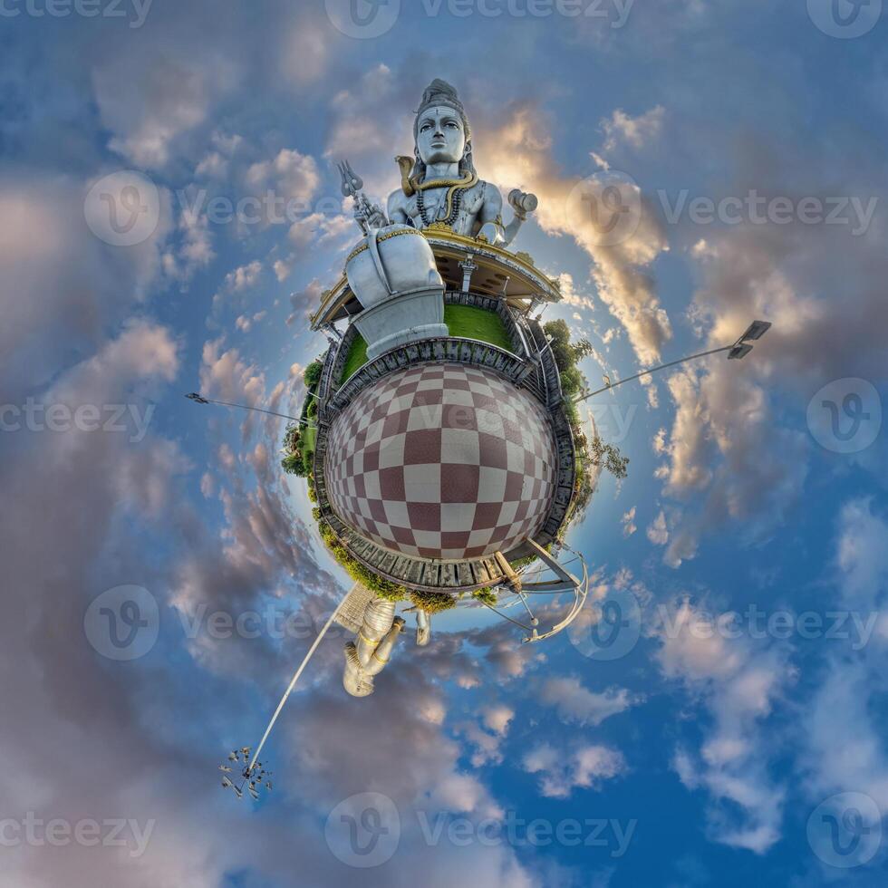 tallest hindu shiva statue in india on mountain near ocean on little planet in blue sky with evening clouds, transformation of spherical 360 panorama. Spherical abstract view with curvature of space. photo