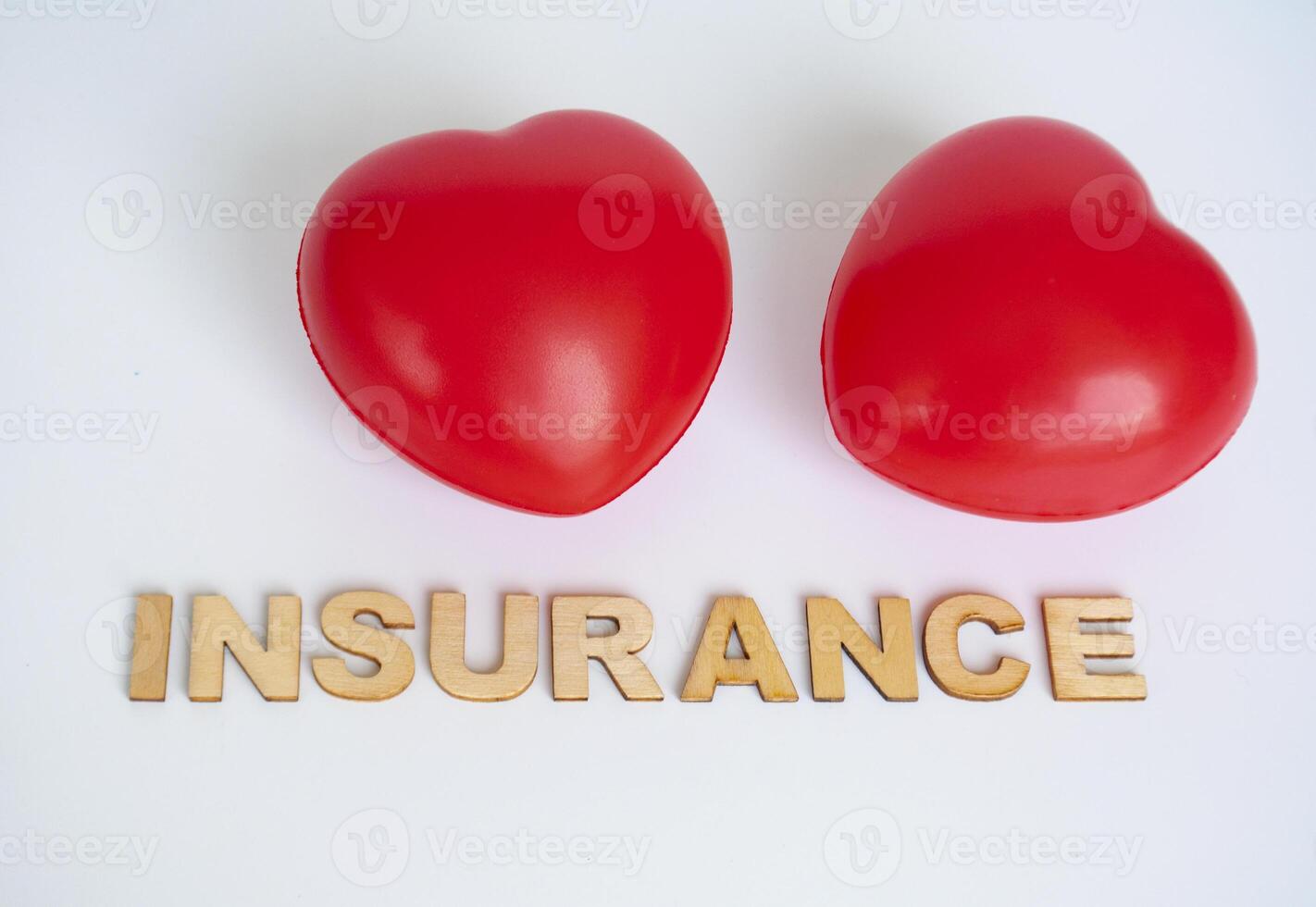 Heart shapes with insurance text on white background. Life insurance concept photo