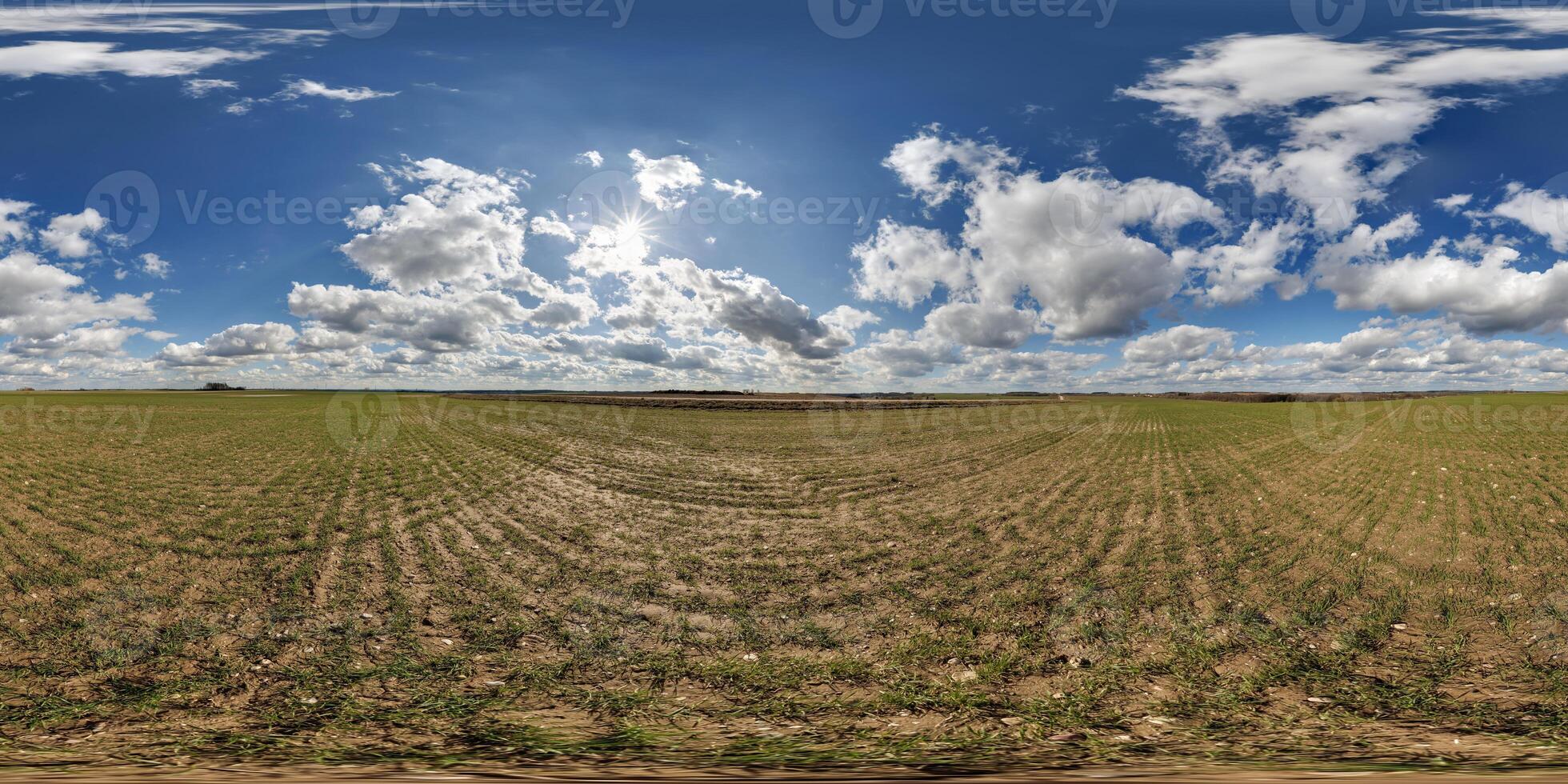 360 hdri panorama view among fields in spring day with beautiful clouds in equirectangular full seamless spherical projection, ready for VR AR or sky dome replacement photo