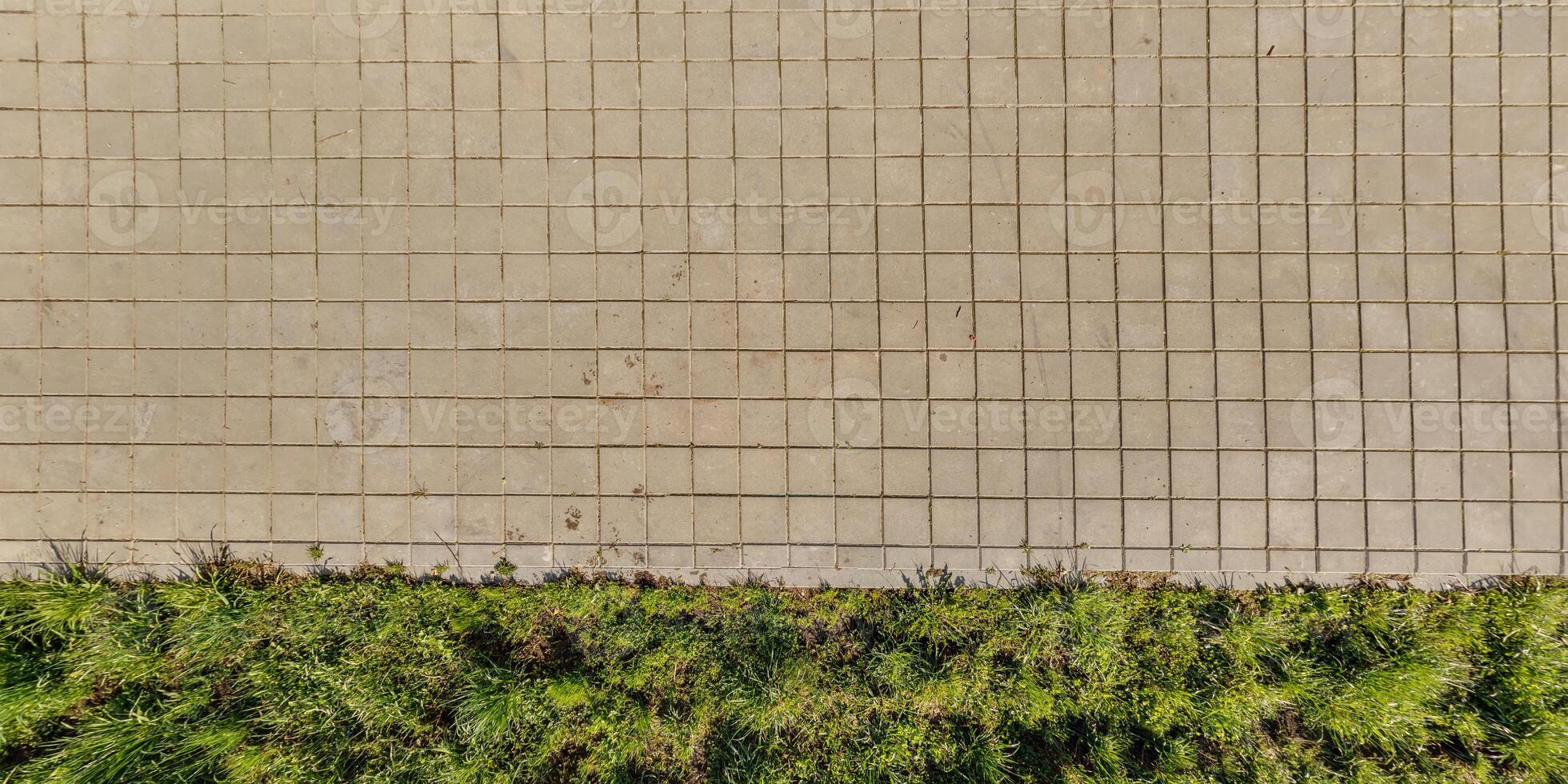 top view of the texture of paving slabs on pedestrian path photo