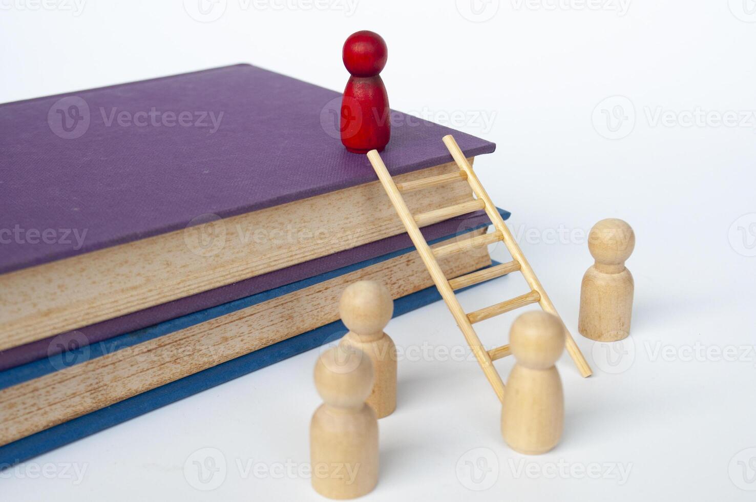 Ladder of success concept with books and doll figure climbing books with ladder photo
