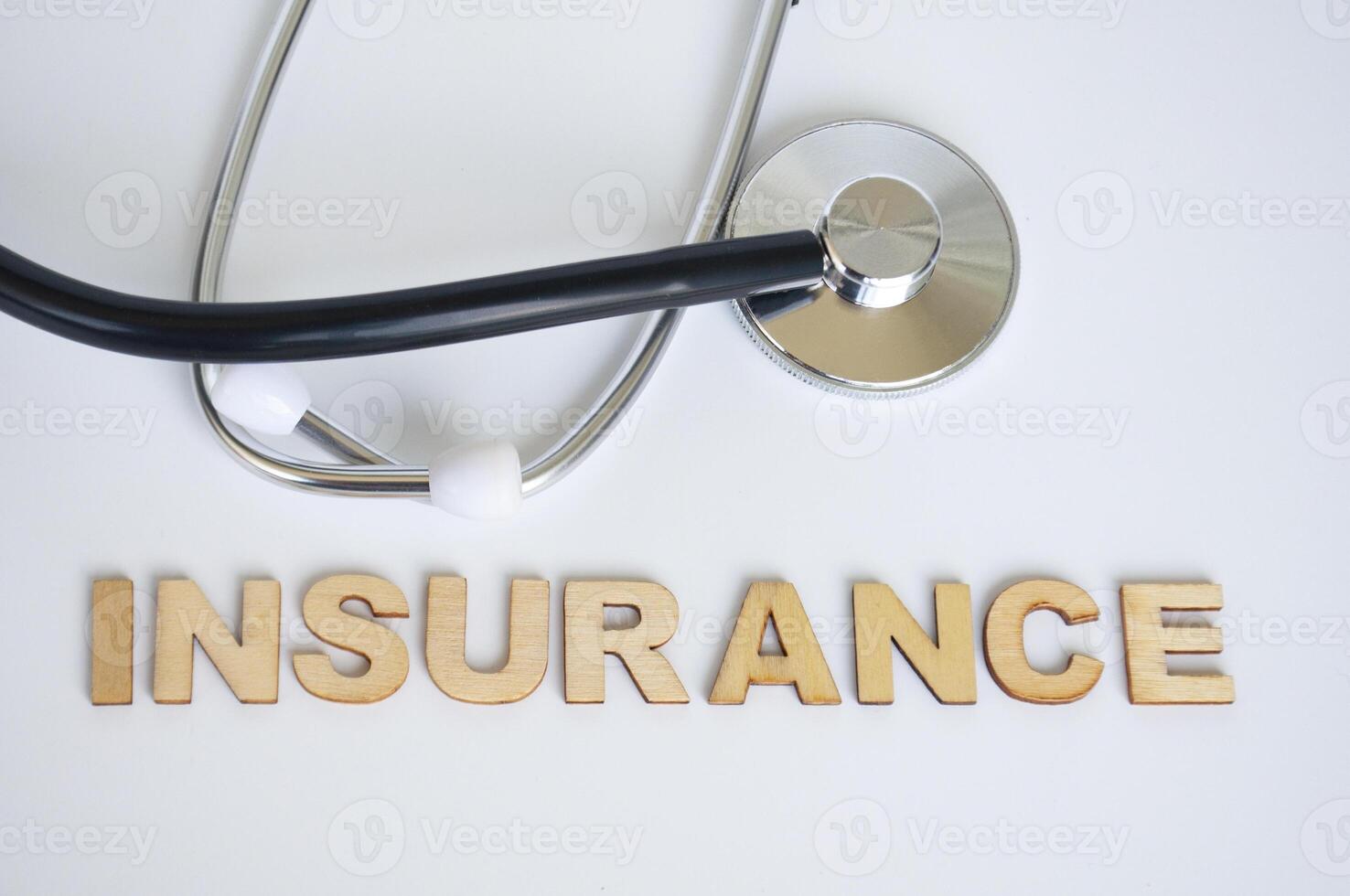 Top view of doctor's stethoscope with Insurance text on white background. Life insurance concept photo