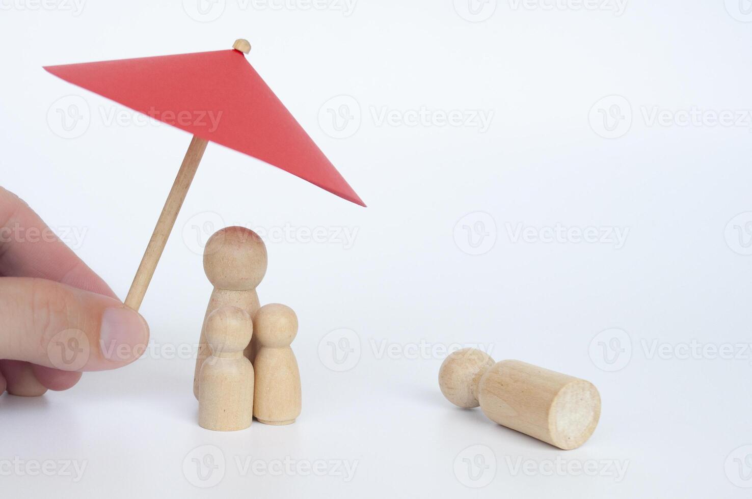 Family wooden dolls covered with insurance due to lost of loves one. Insurance concept. photo
