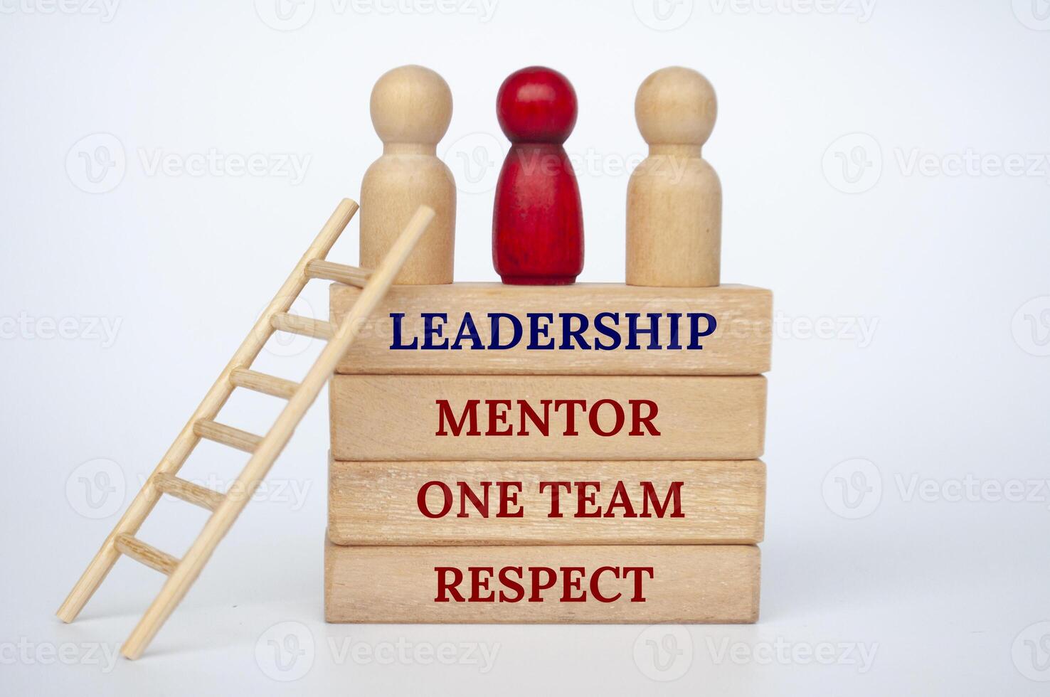 Leadership concept with doll figures on top of wooden blocks with wooden ladder photo