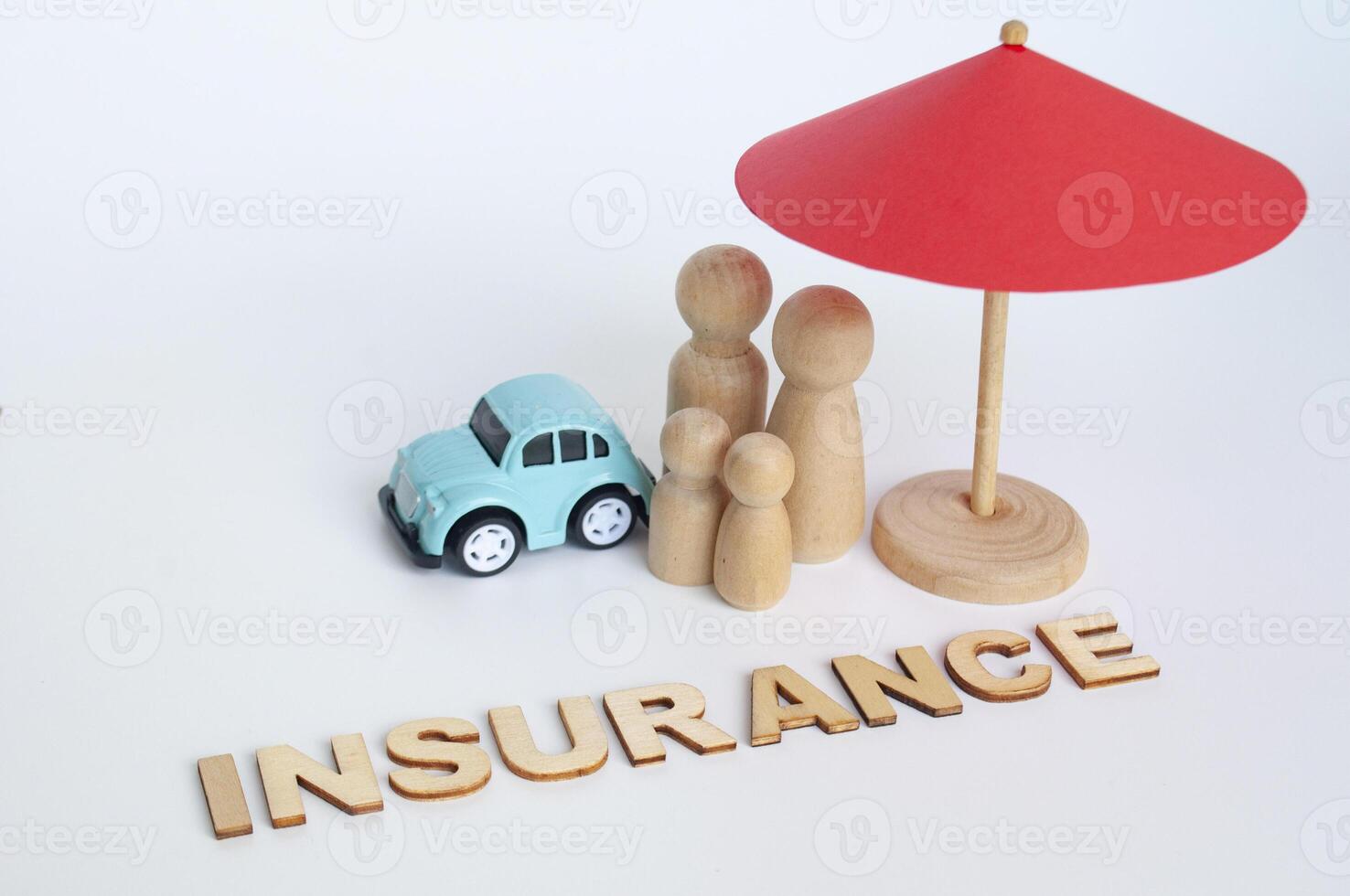 Red umbrella, wooden family doll figures and a car. Insurance coverage concept photo
