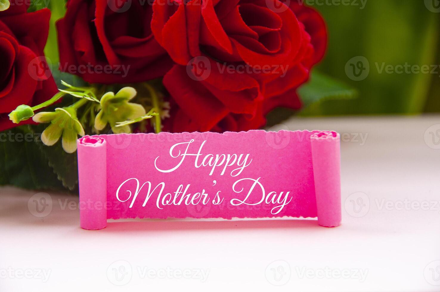 Happy mother's day text on pink paper with roses background. Mother's day concept. photo