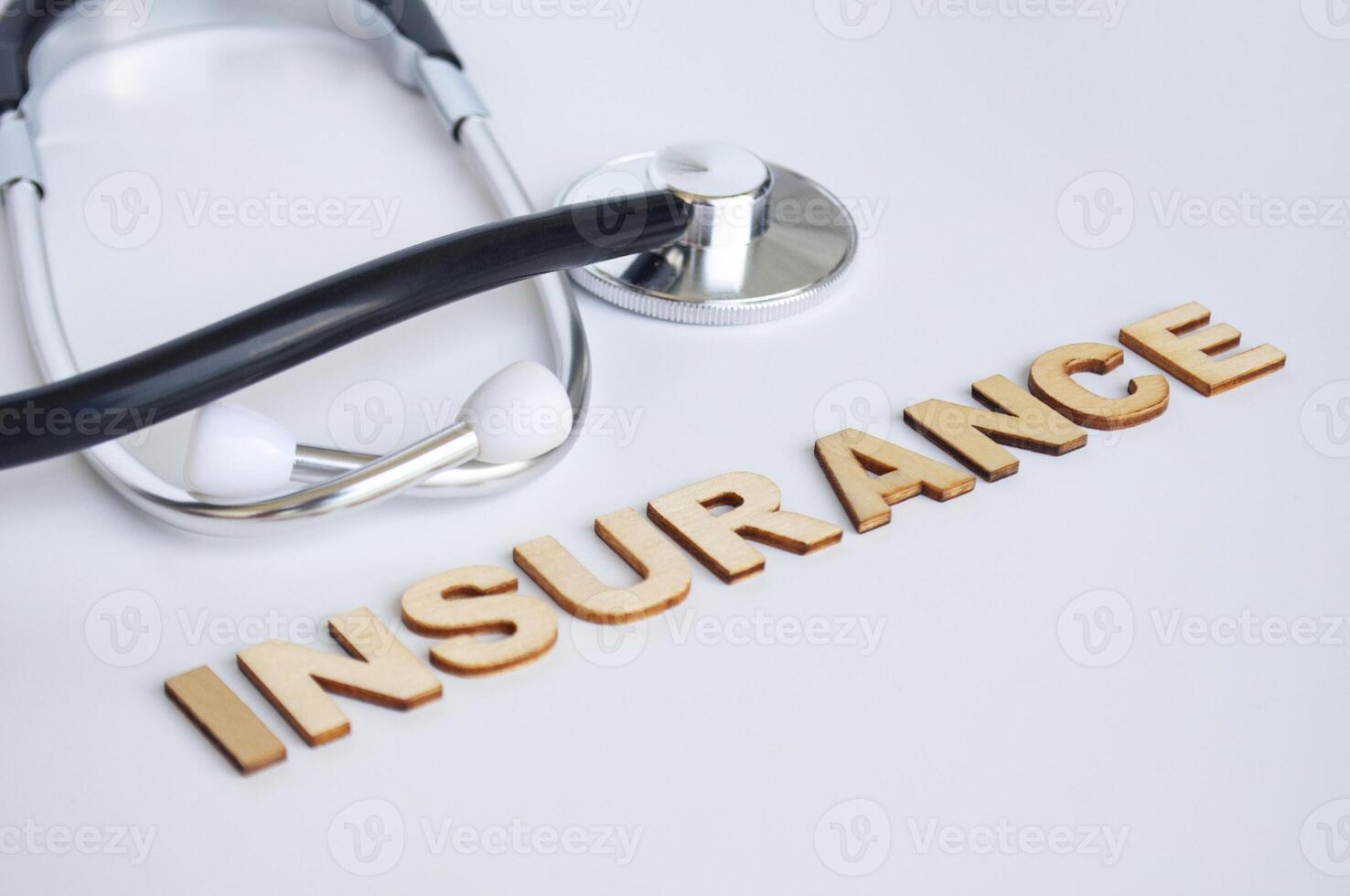 Doctor's stethoscope with Insurance text on white background. Life insurance concept photo