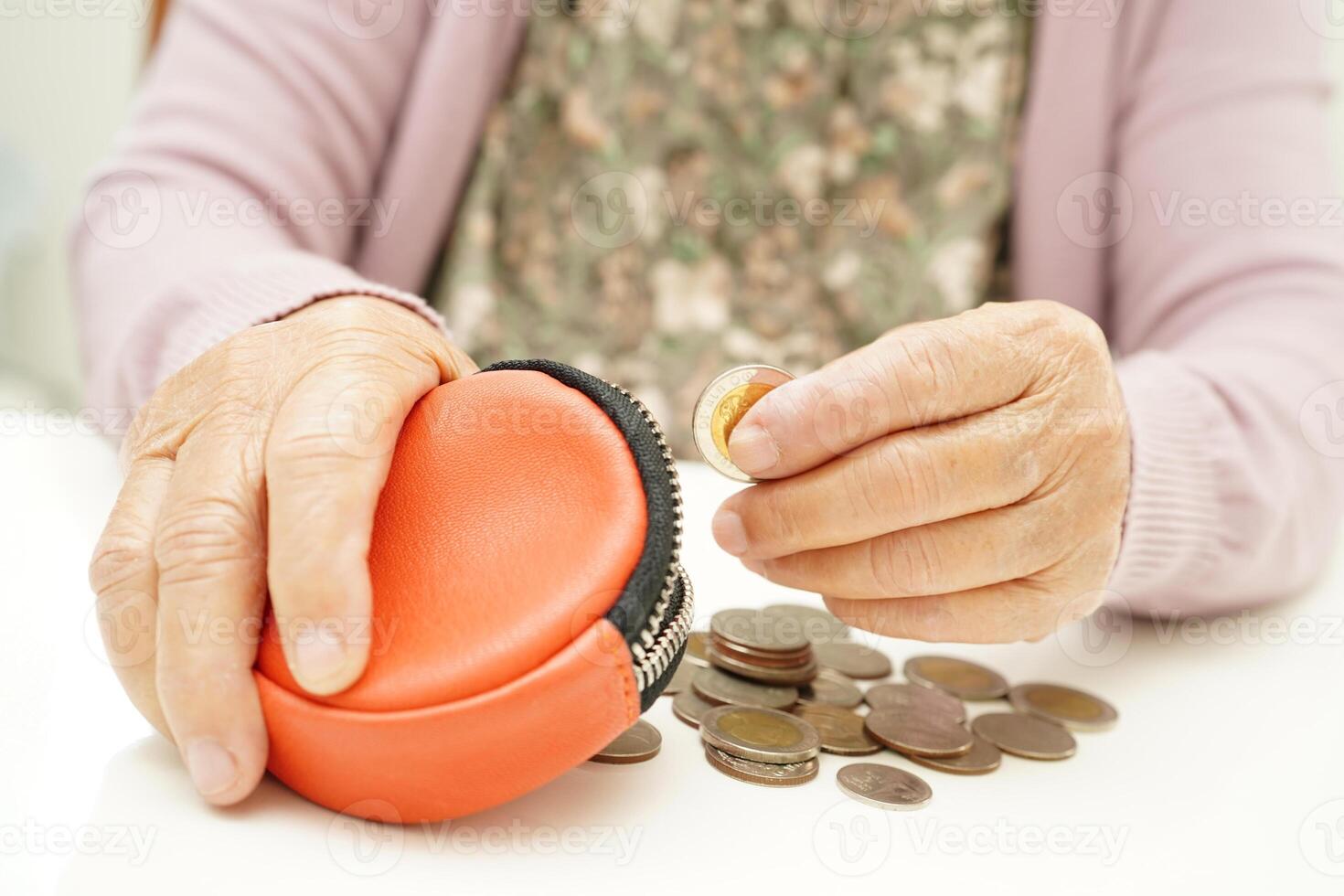 Retired elderly woman counting coins money and worry about monthly expenses and treatment fee payment. photo