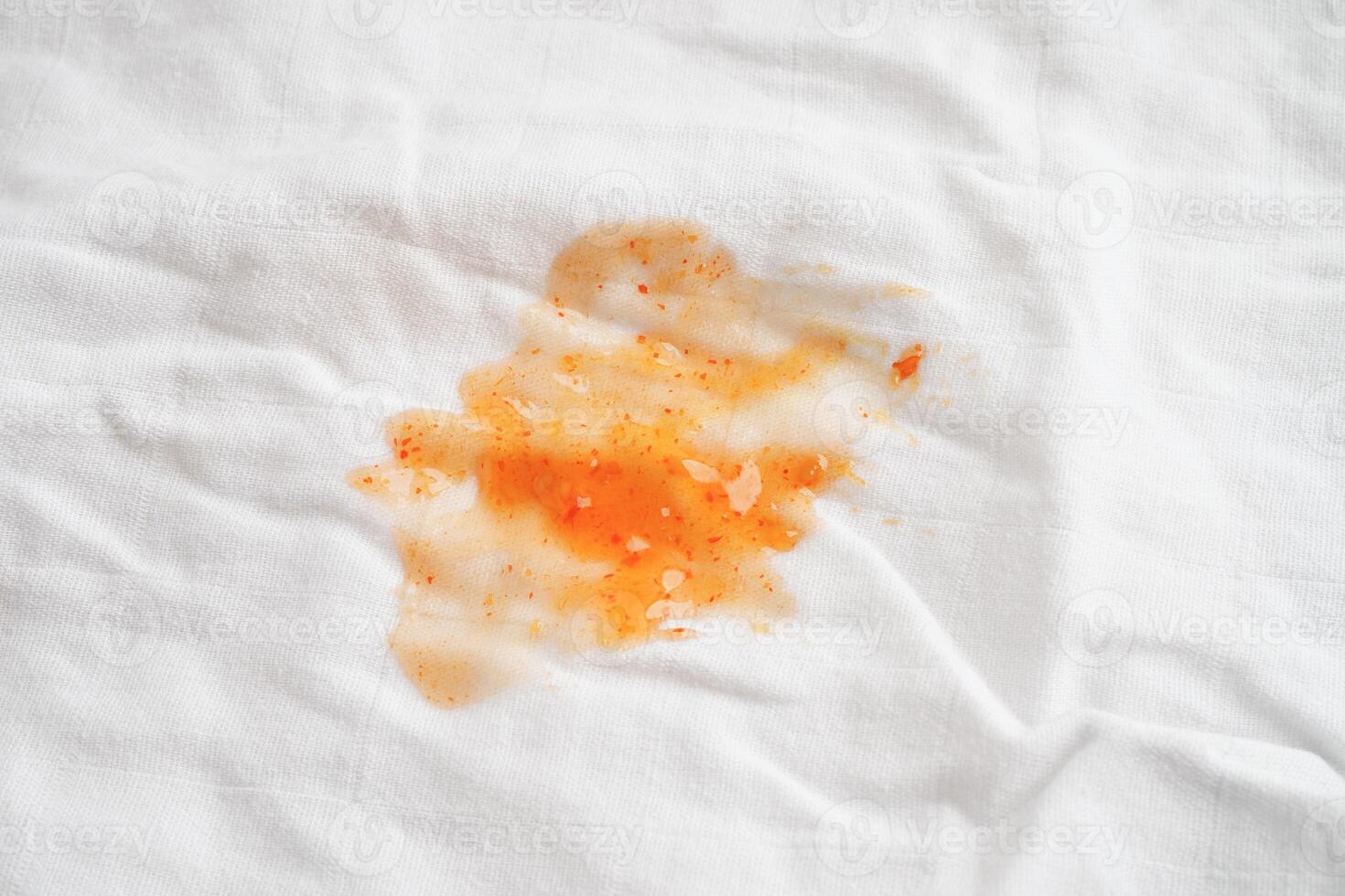 Dirty spicy sauce stain on cloth to wash with washing powder, cleaning housework concept. photo