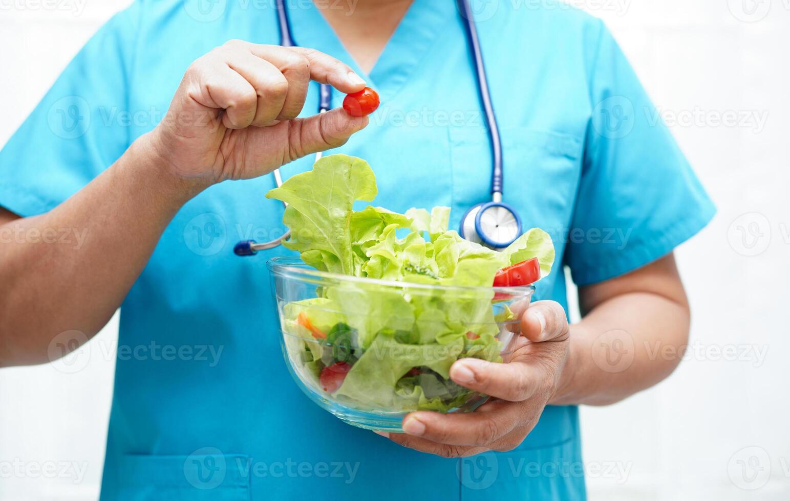 Asian Nutritionist holding healthy food for patient in hospital, nutrition and vitamin. photo