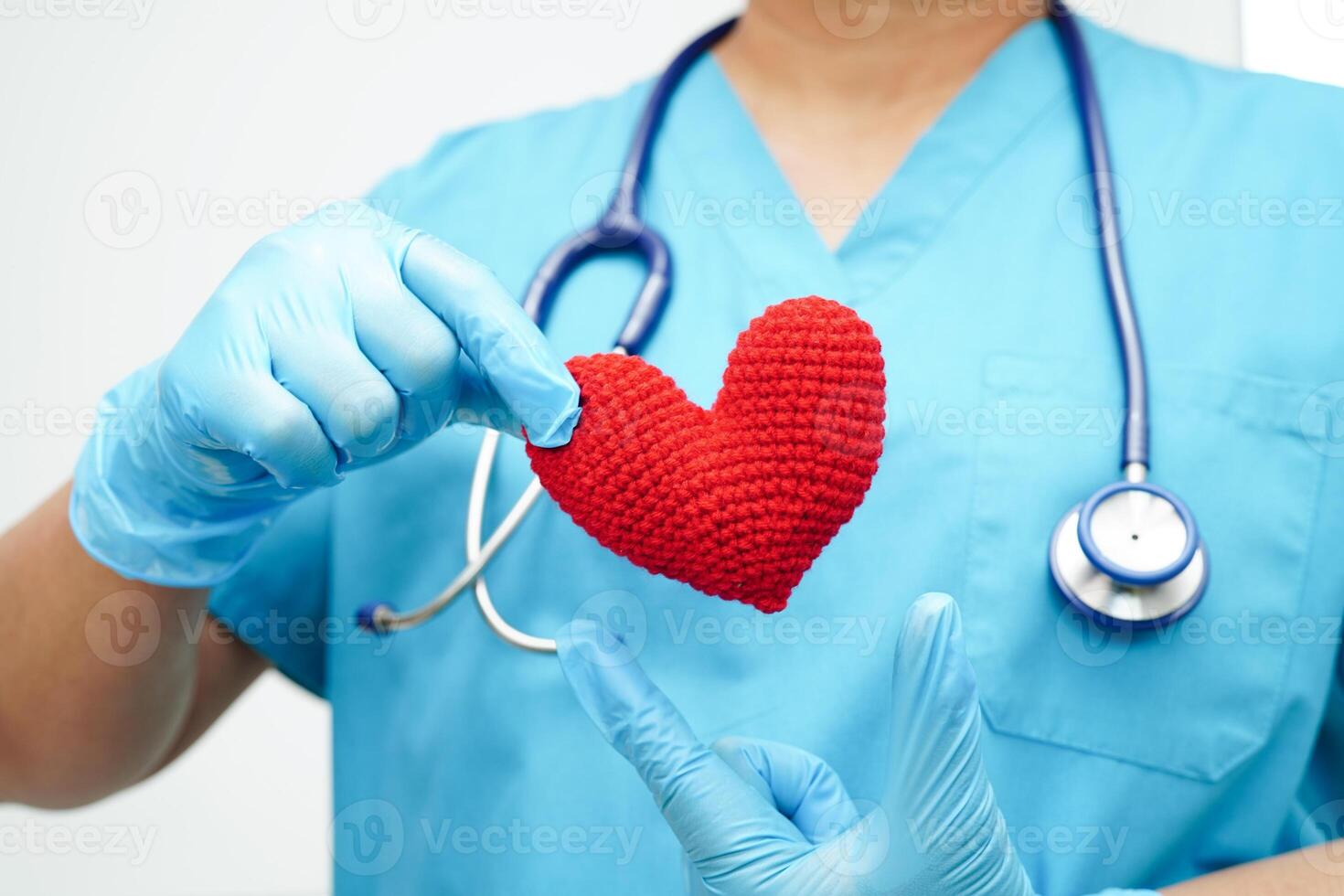 Asian woman doctor holding red heart for health in hospital. photo