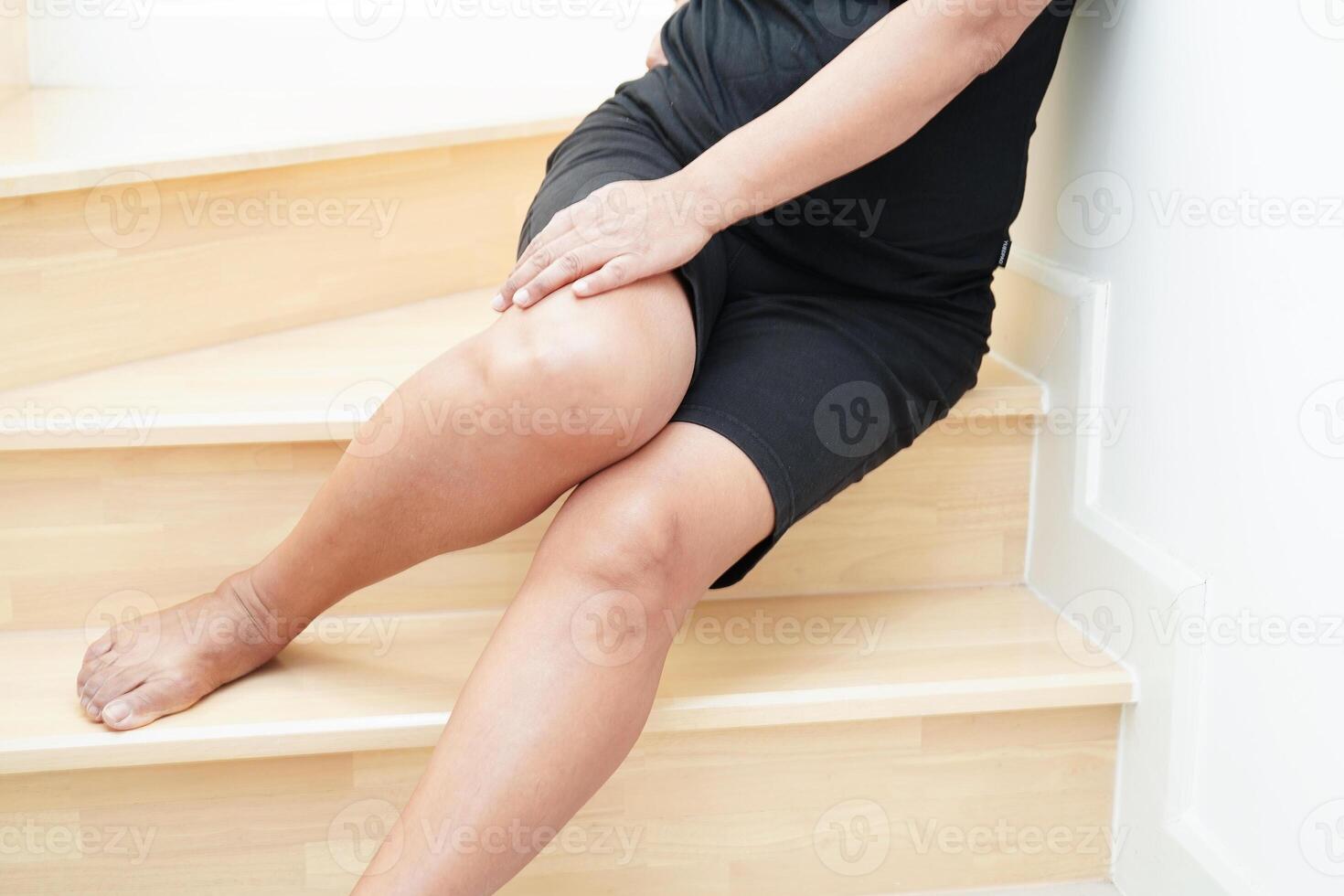 Asian lady woman injury from falling down on slippery surfaces stairs at home. photo