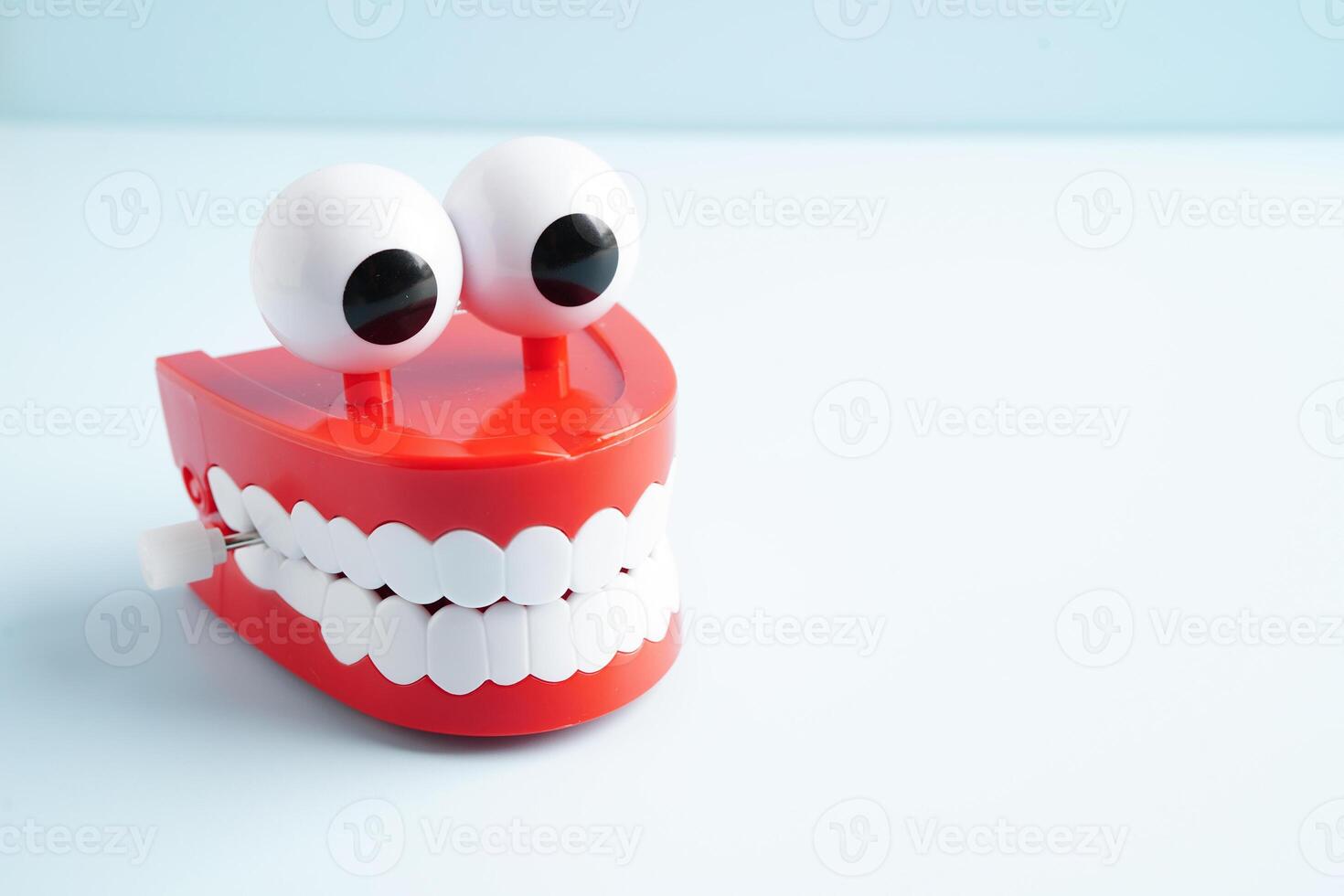 Funny red teeth with eye toy denture model for dental health care. photo