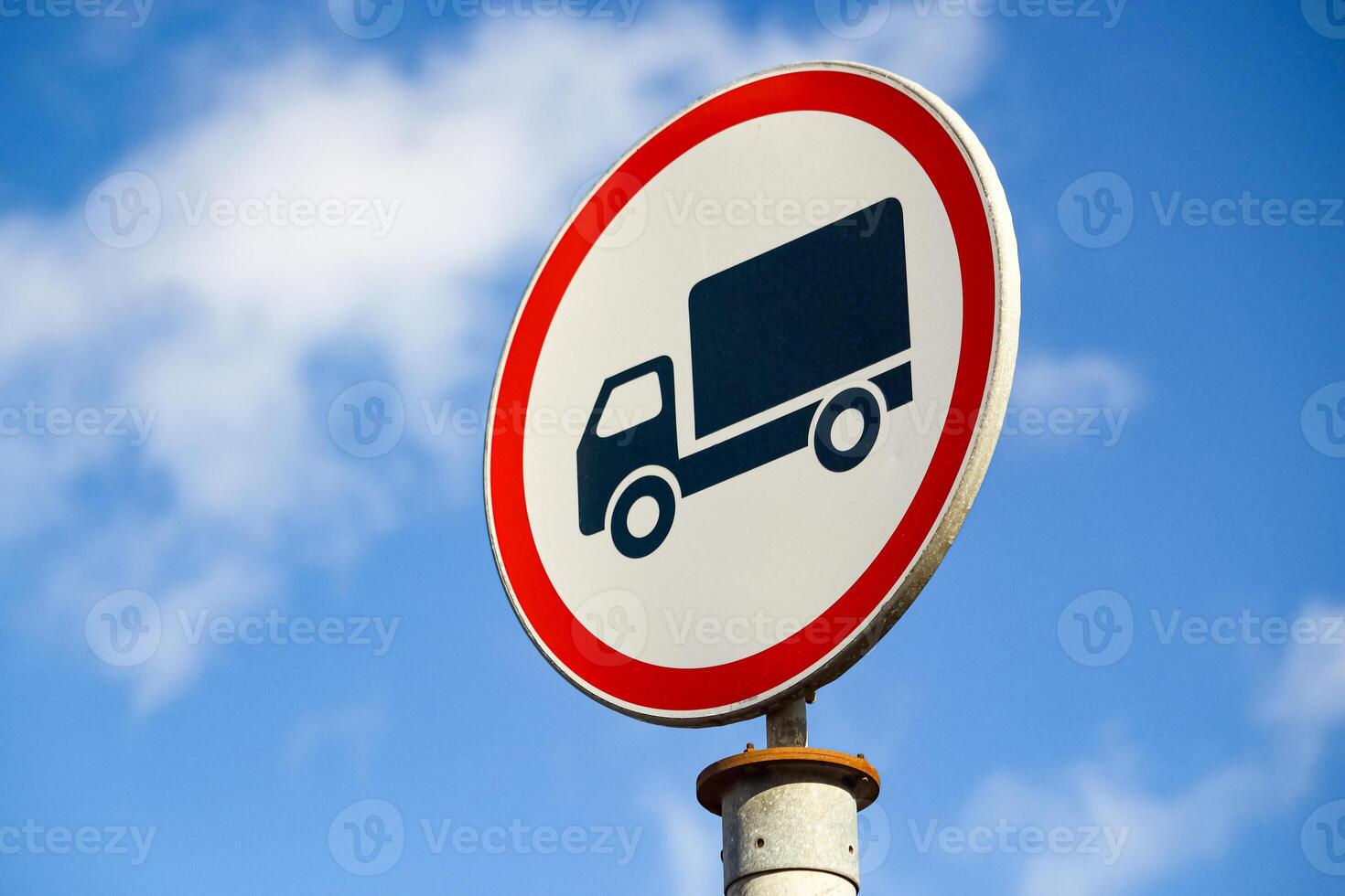 Road sign no truck entrance with red circle frame on blue sky background photo
