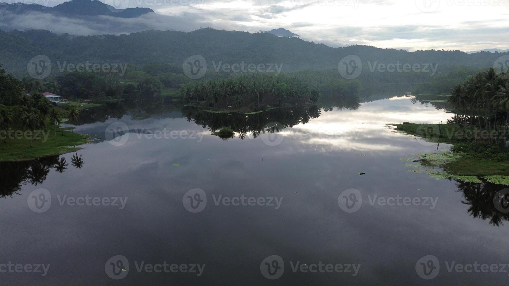 Aerial view of Perintis Lake surrounded by trees photo