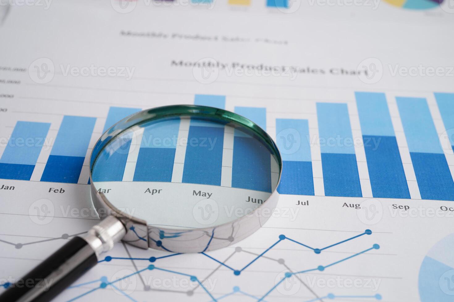 Magnifying glass on charts graphs paper. Financial development, Banking Account, Statistics, Investment Analytic research data economy. photo