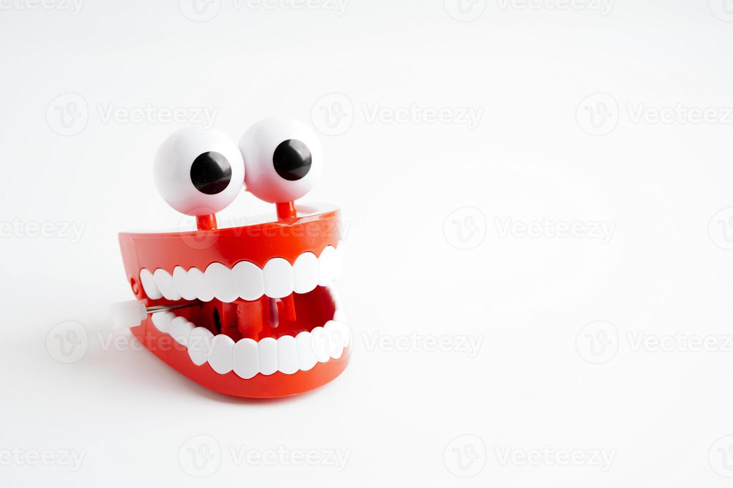 Funny red teeth with eye toy denture model for dental health care. photo