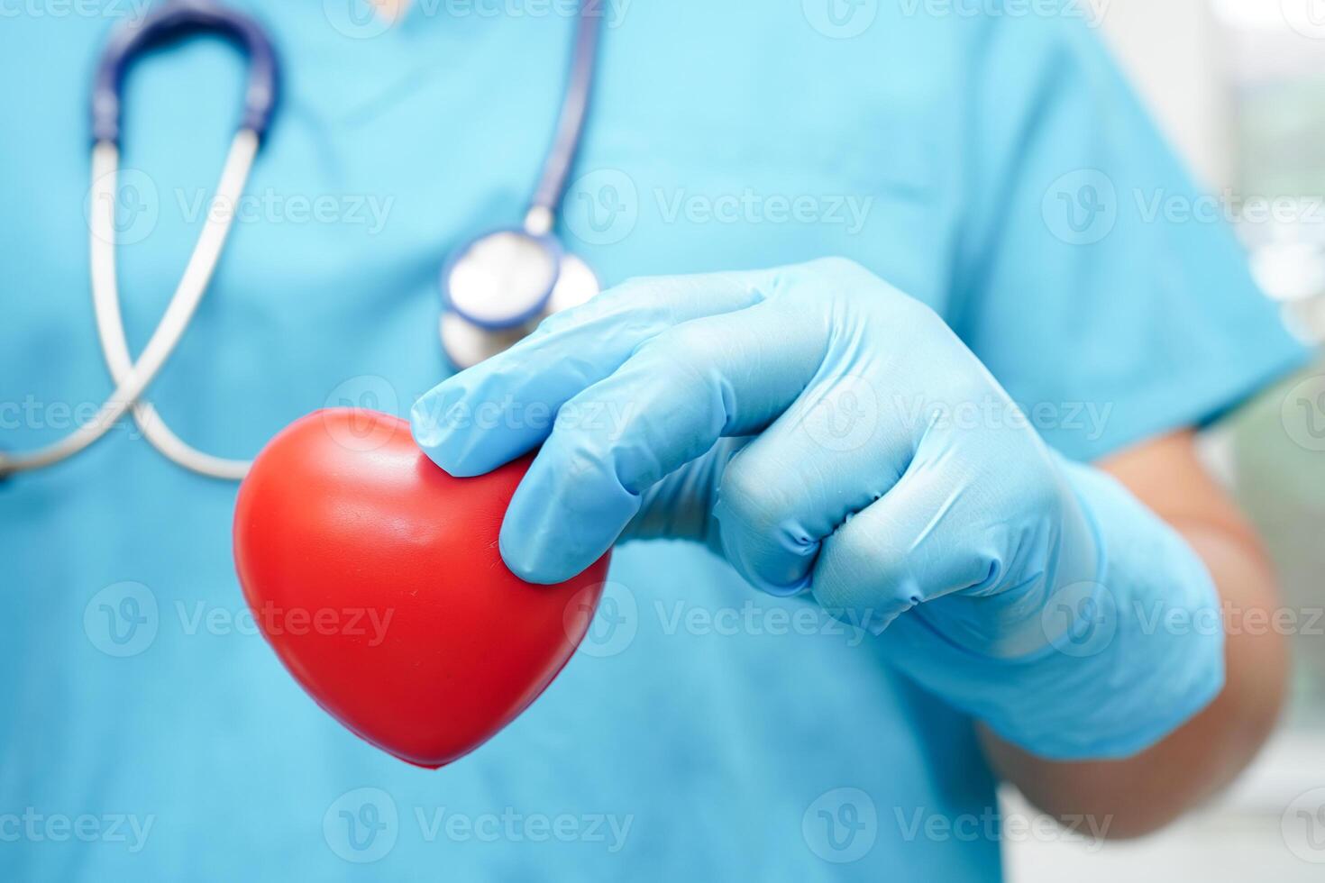 Asian woman doctor holding red heart for health in hospital. photo