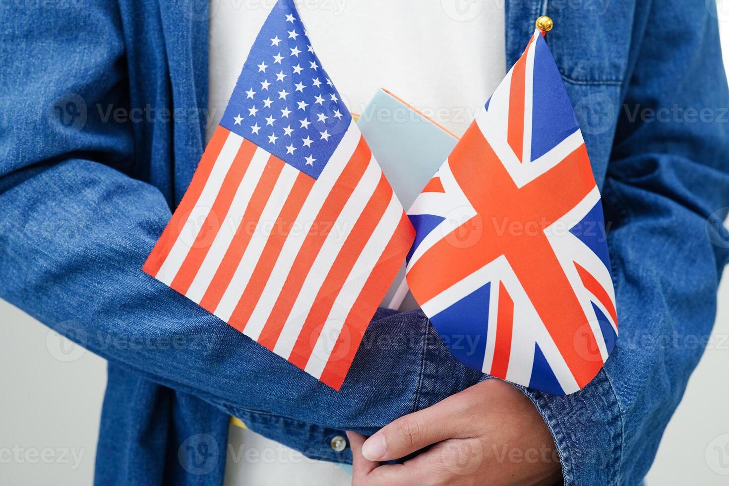 Learning English, Asian teenage student holding book with flag for language program education. photo