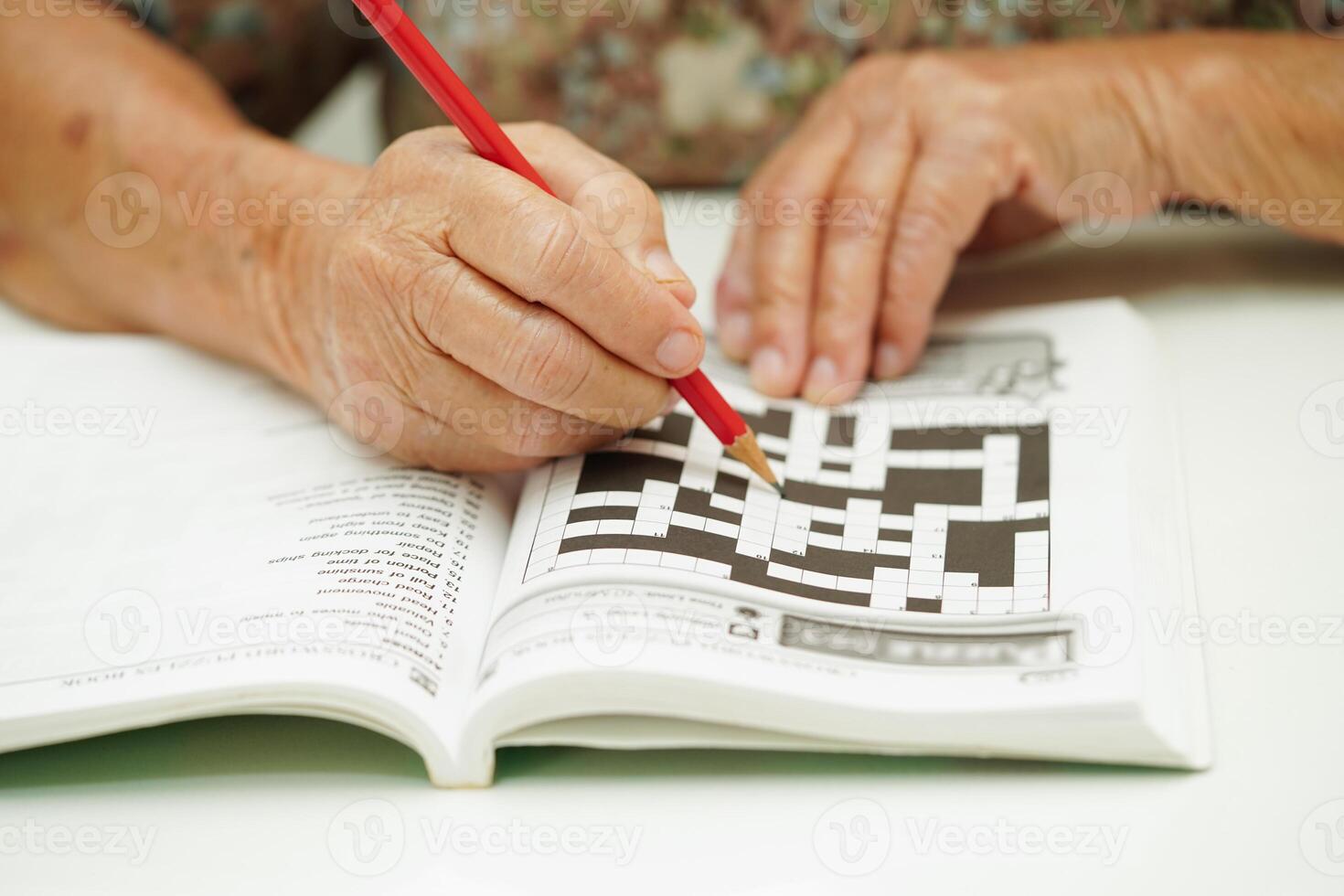 elderly woman playing sudoku puzzle game for treatment dementia prevention and Alzheimer disease. photo