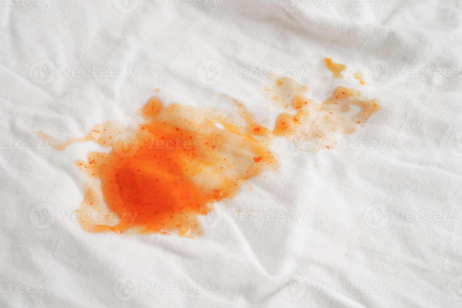 Dirty spicy sauce stain on cloth to wash with washing powder, cleaning housework concept photo