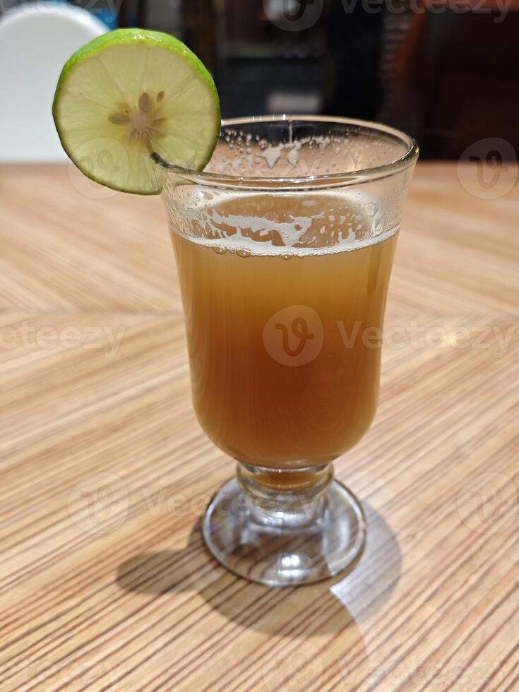 Golden Temulawak Herbal Drink in Glass, Authentic Indonesian Beverage photo