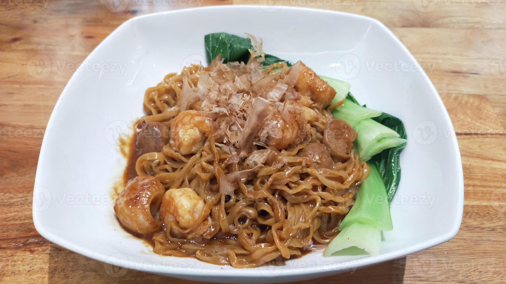 Gourmet Truffle Oil Seafood Fried Noodles on Elegant White Plate photo