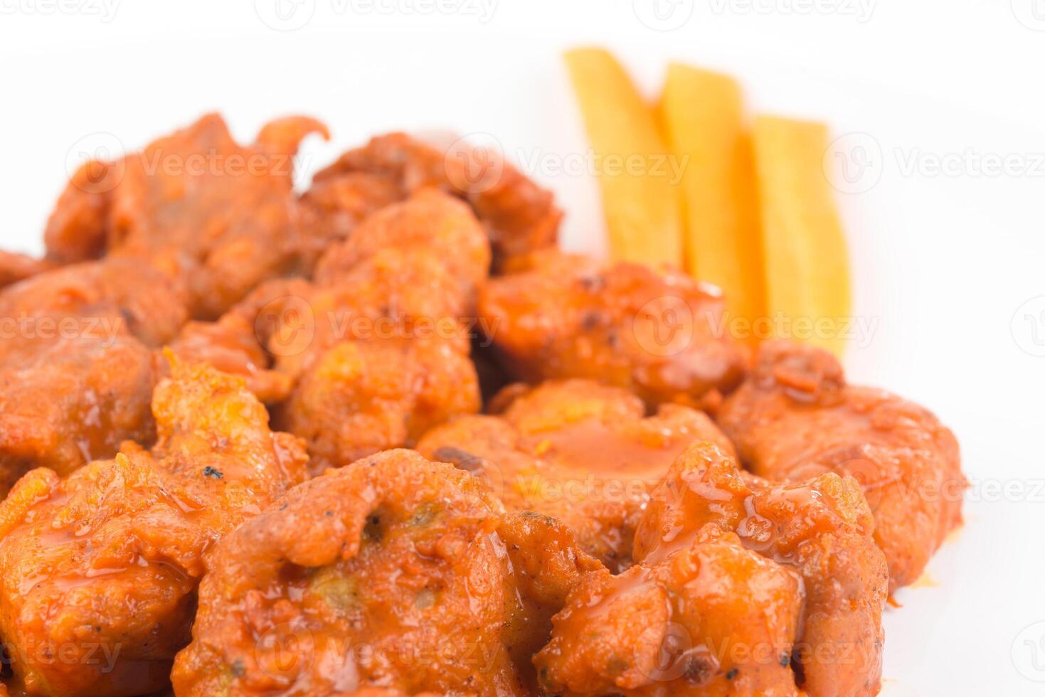 Boneless chicken wings with buffalo sauce and carrots photo