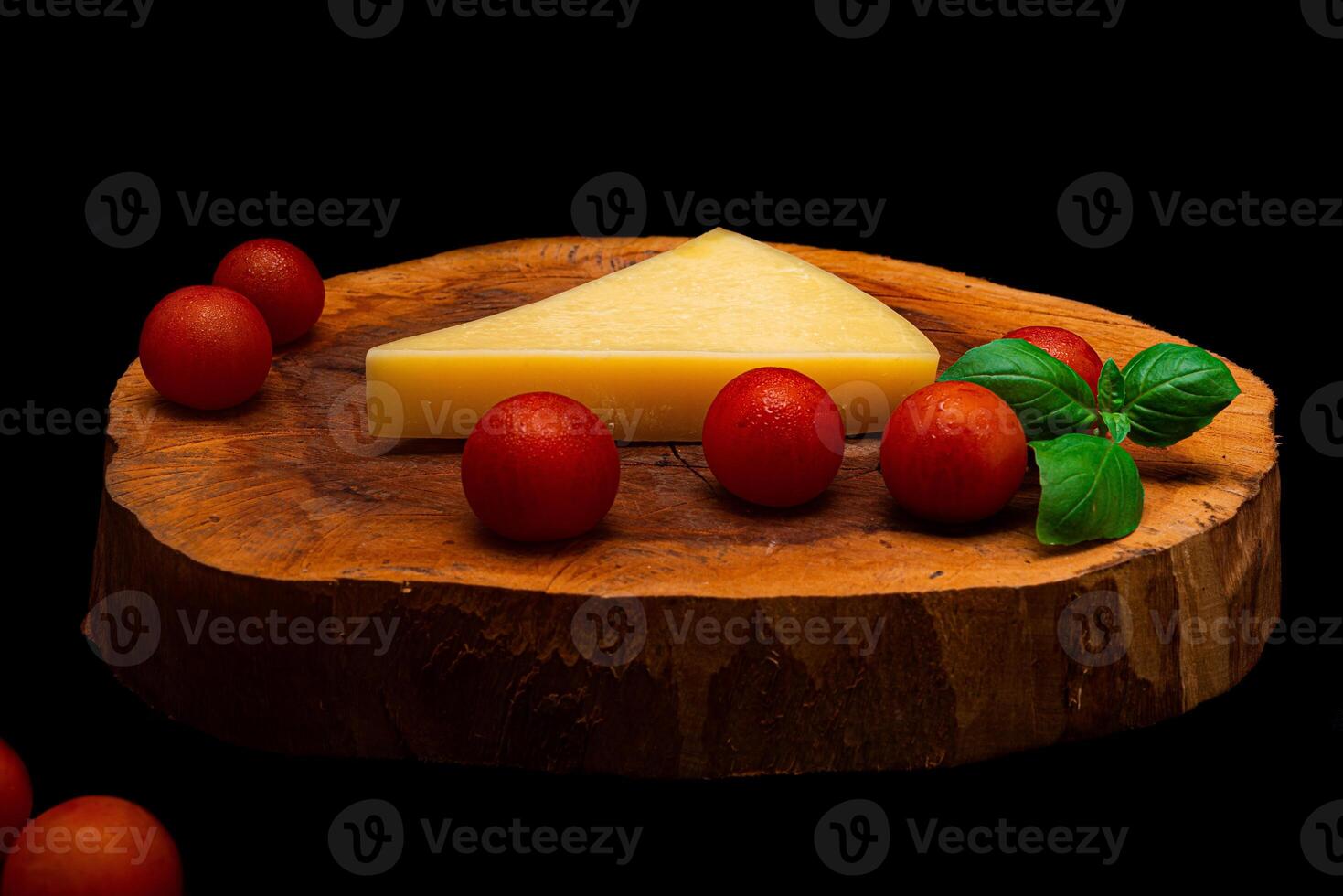 Composition of vegetables and cheese over a wooden plate photo