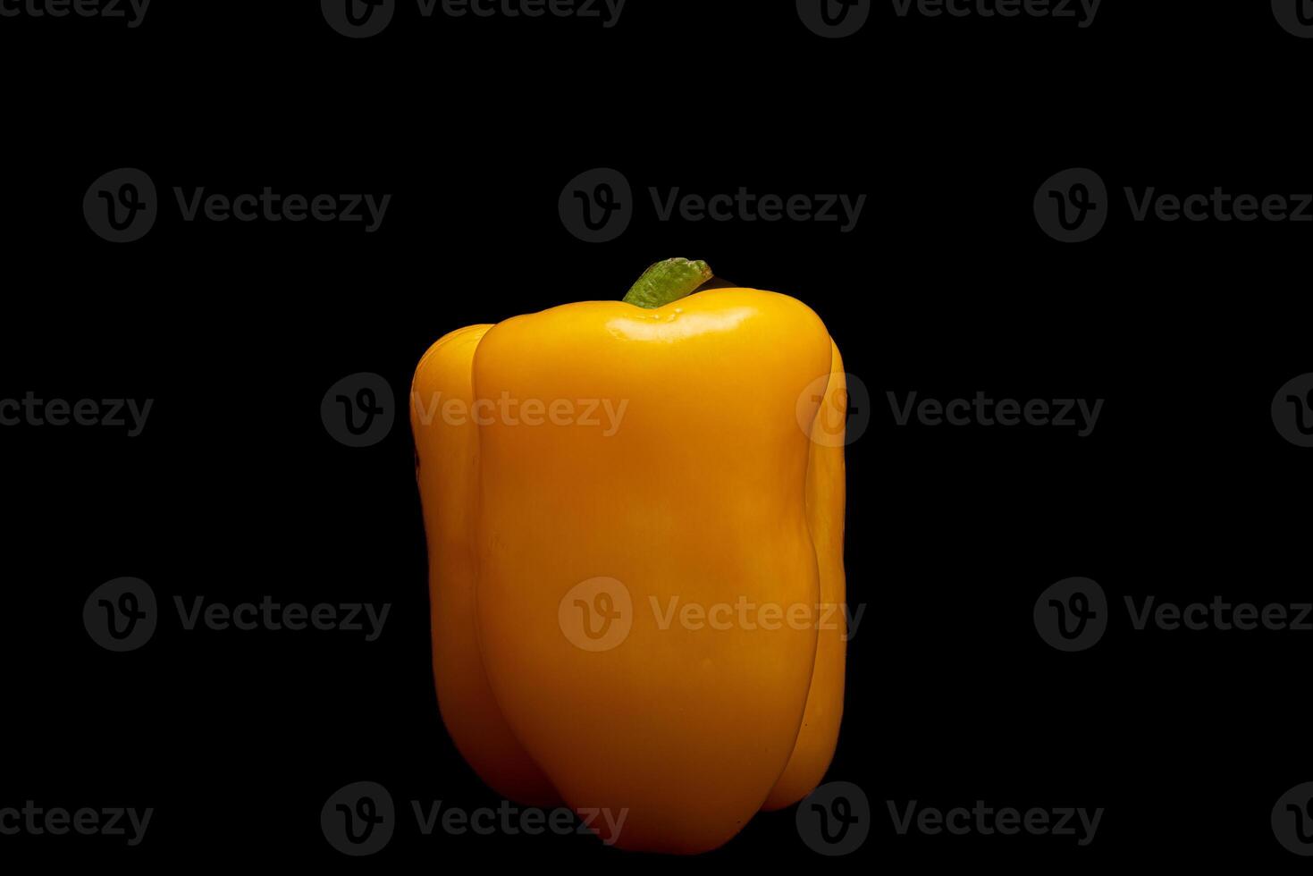 Yellow pepper in black background photo