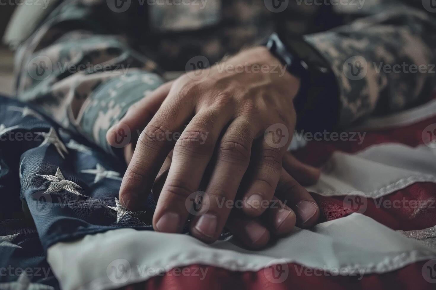 A man in a military uniform is holding a hand on a flag photo