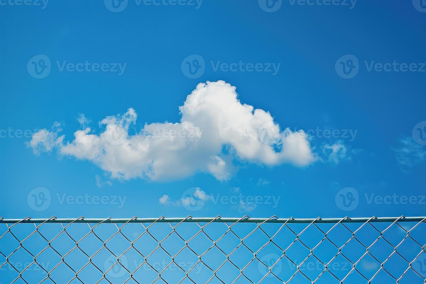 A cloudless blue sky with a large cloud in the middle photo