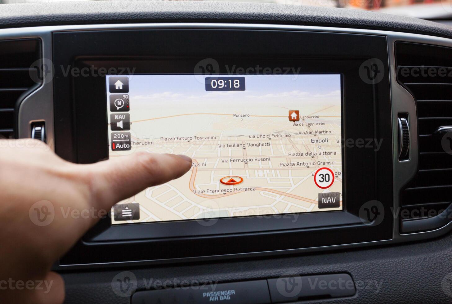 Navigation panel inside a car. Finger pointing on destination point. photo