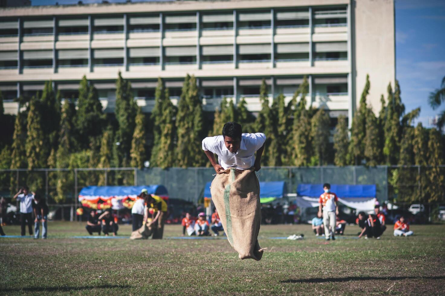 ChiangMai Thailand  November 30 2022  Asian teenage students are doing a sack race for unity in Chiang Mai Rajabhat University photo