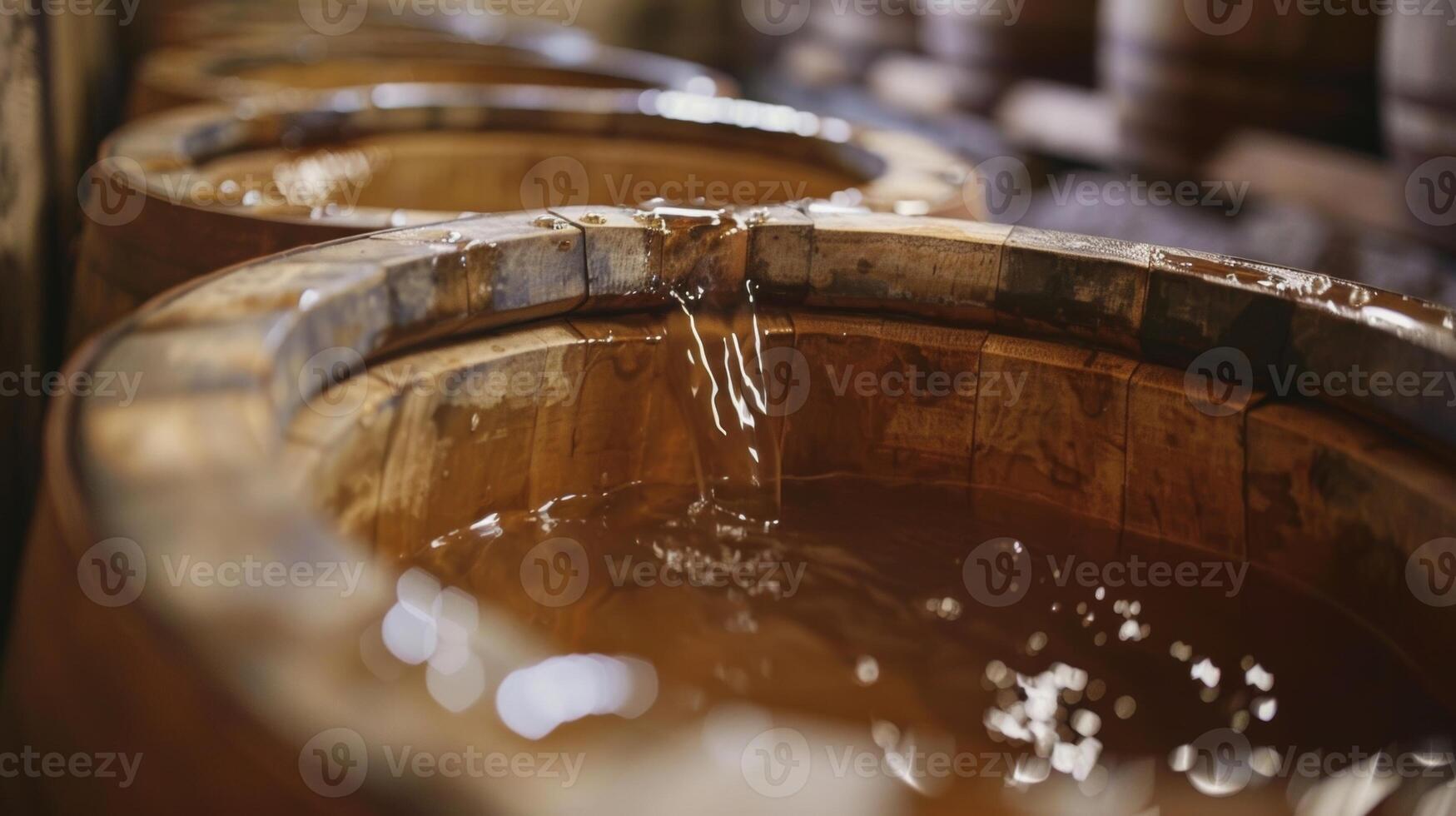 Wooden barrels filled with spring water are carefully labelled and sampled by curious attendees photo