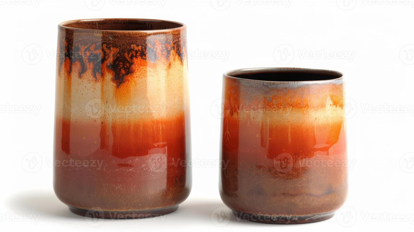 A pair of cylindrical vases with a dipdyed glaze effect featuring a blend of dark and light shades of orange creating a sunsetlike appearance. photo