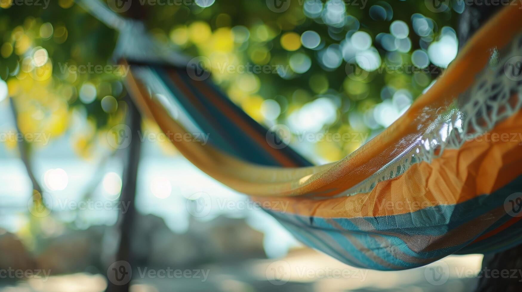 An empty hammock swaying in the breeze as a man takes a nap unplugged from the digital demands of everyday life photo