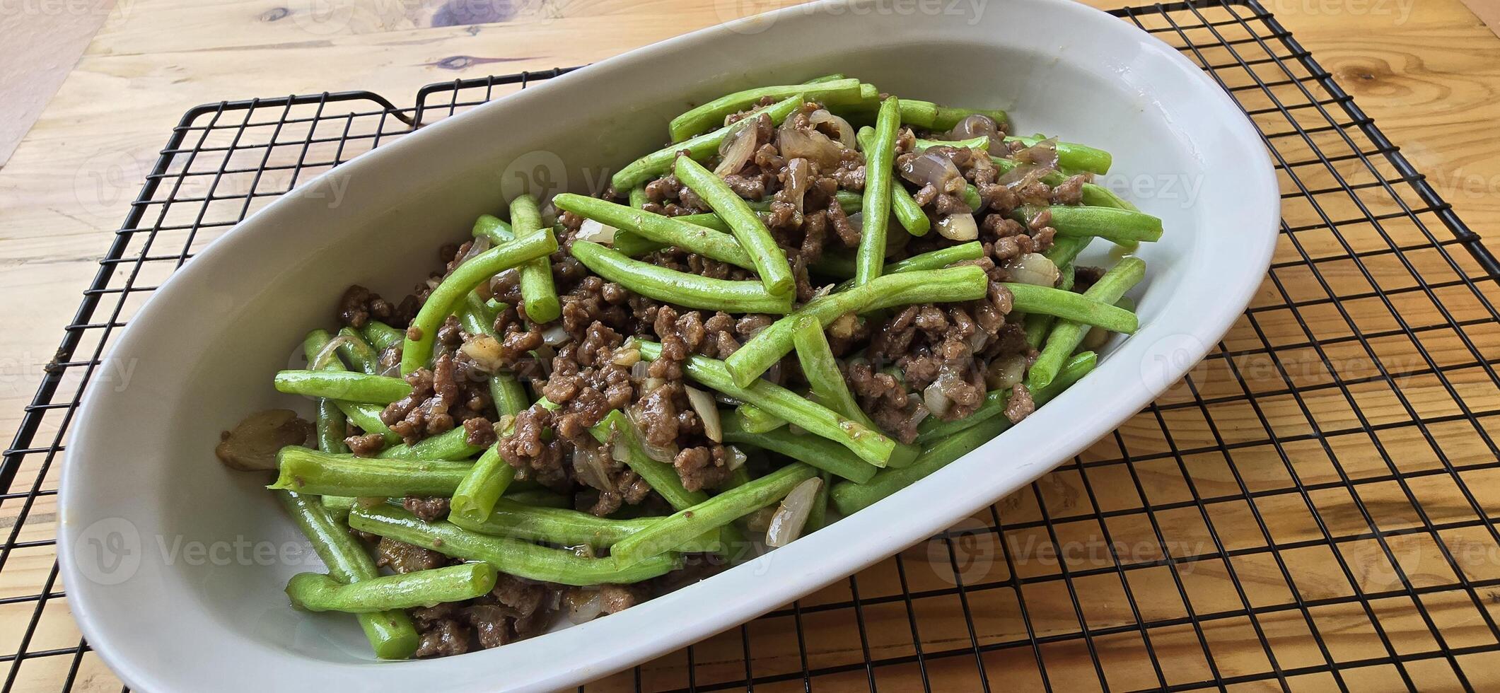 String green bean or french beans with minced beef stir fry or sauteed called Tumis buncis daging sapi cincang in Indonesia photo
