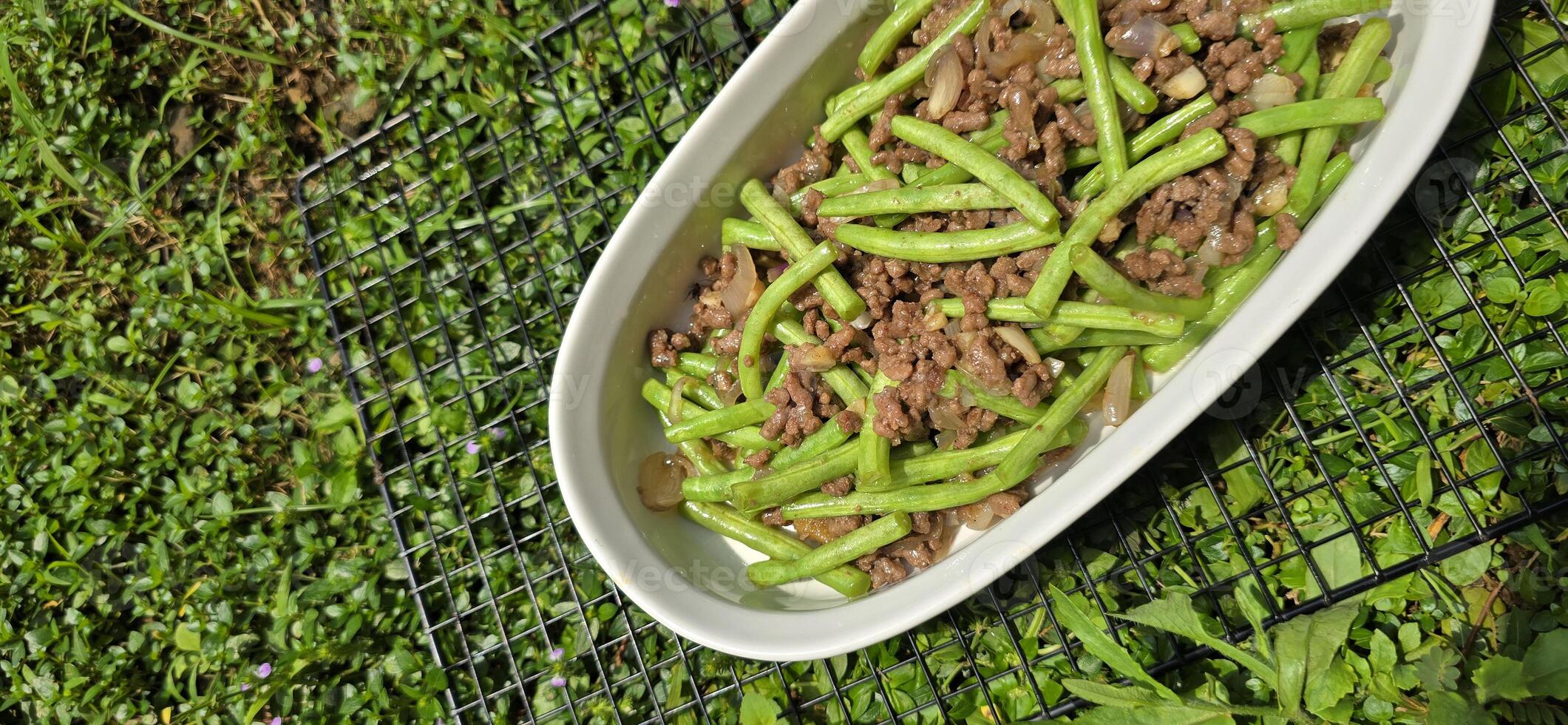 String green bean or french beans with minced beef stir fry or sauteed called Tumis buncis daging sapi cincang in Indonesia photo