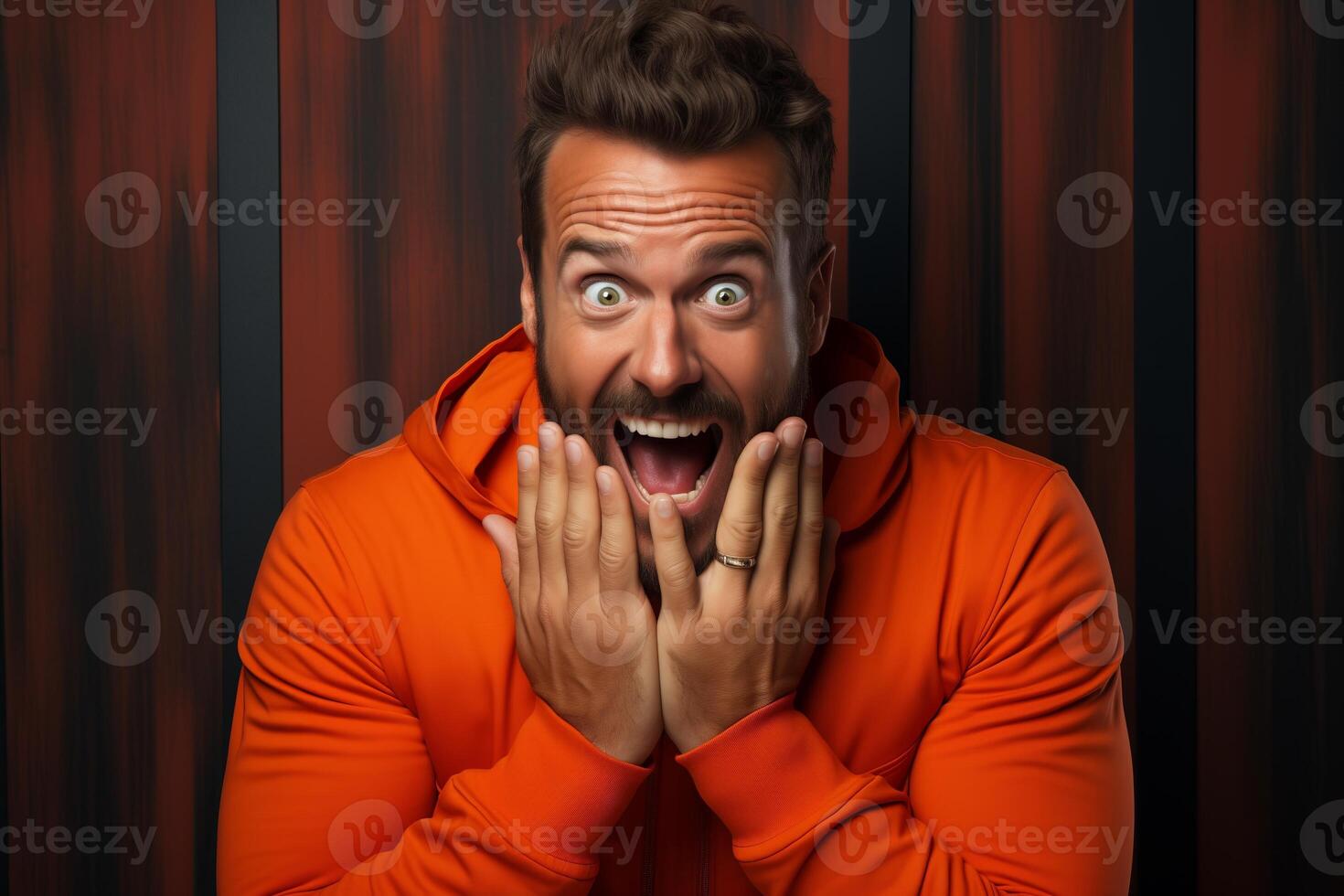 A cheerful man displaying a surprised expression on his face, with widened eyes and open mouth. photo