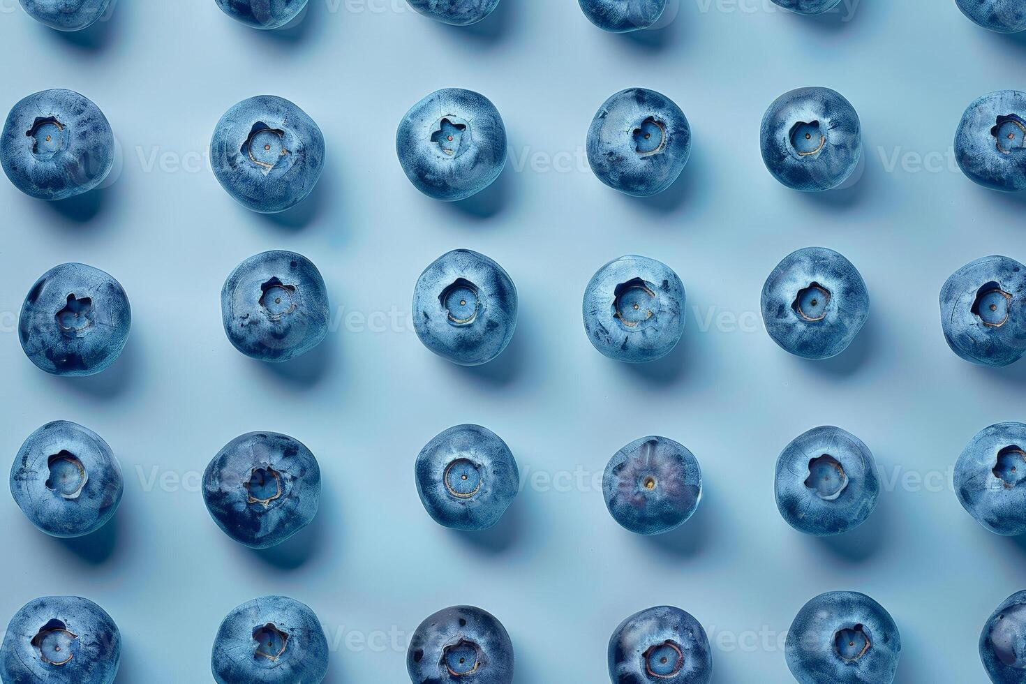Faded blueberries arranged in a sparse pattern, muted blue tones on a clean background photo