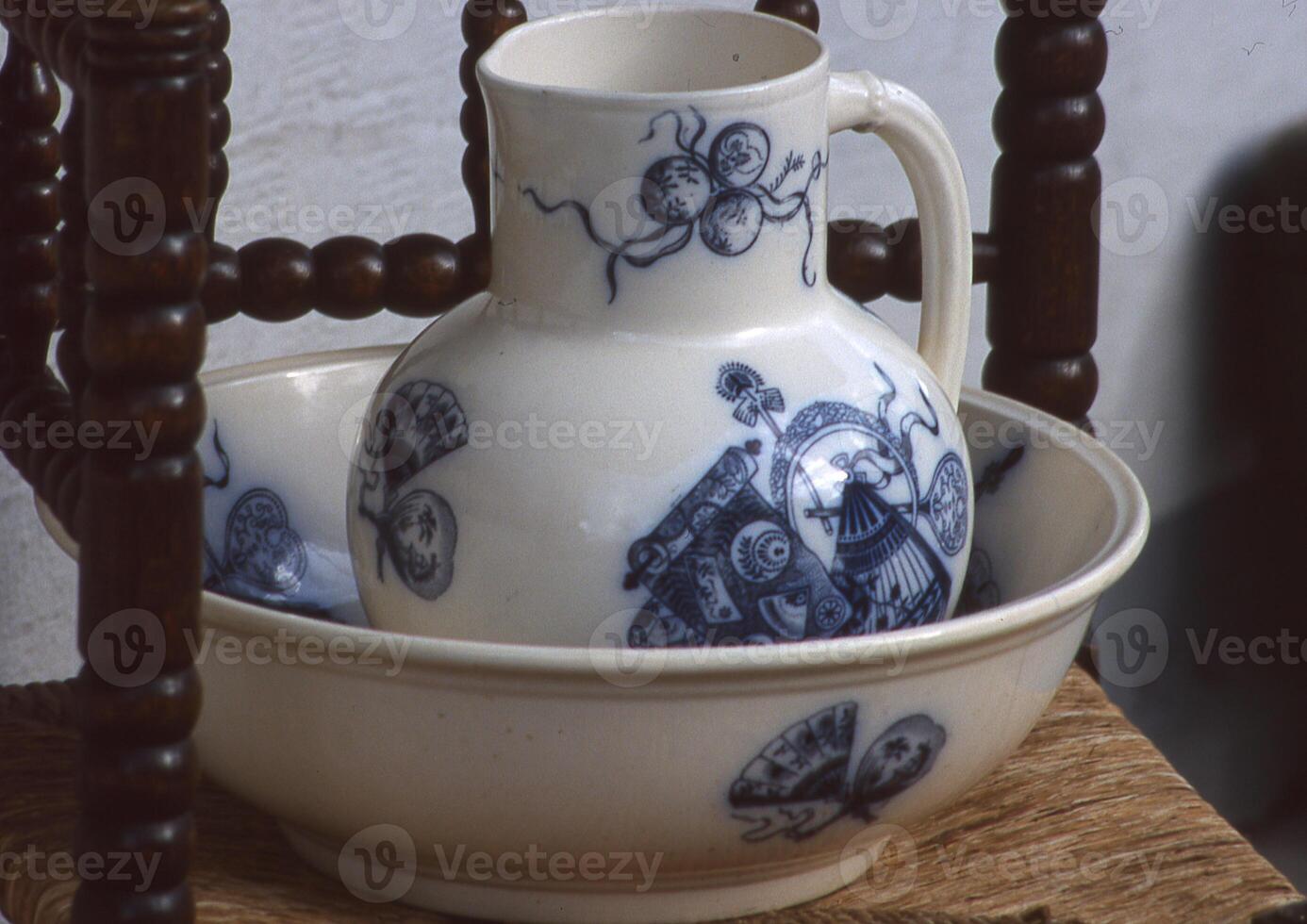 a bowl and a pitcher sitting on a chair photo